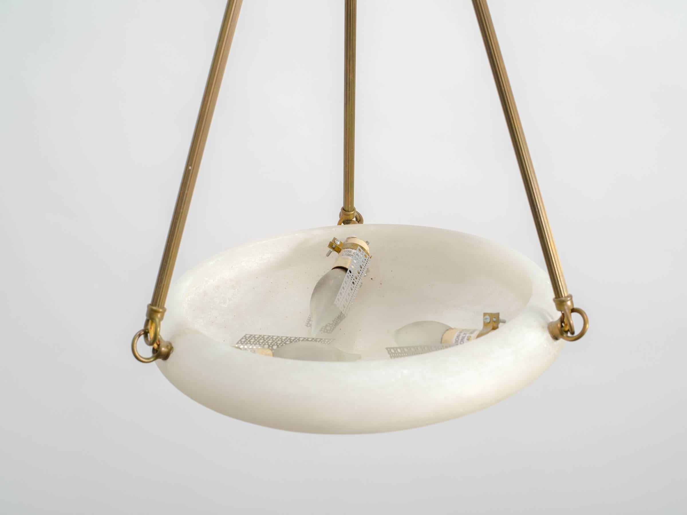 Pair of alabaster and brass chandeliers. The hanging rods are different on the chandeliers. One chandelier has readed rods, the other has plain rods. This can easily be changed to all plain hanging rods. Heat marks on one fixture that looks dark