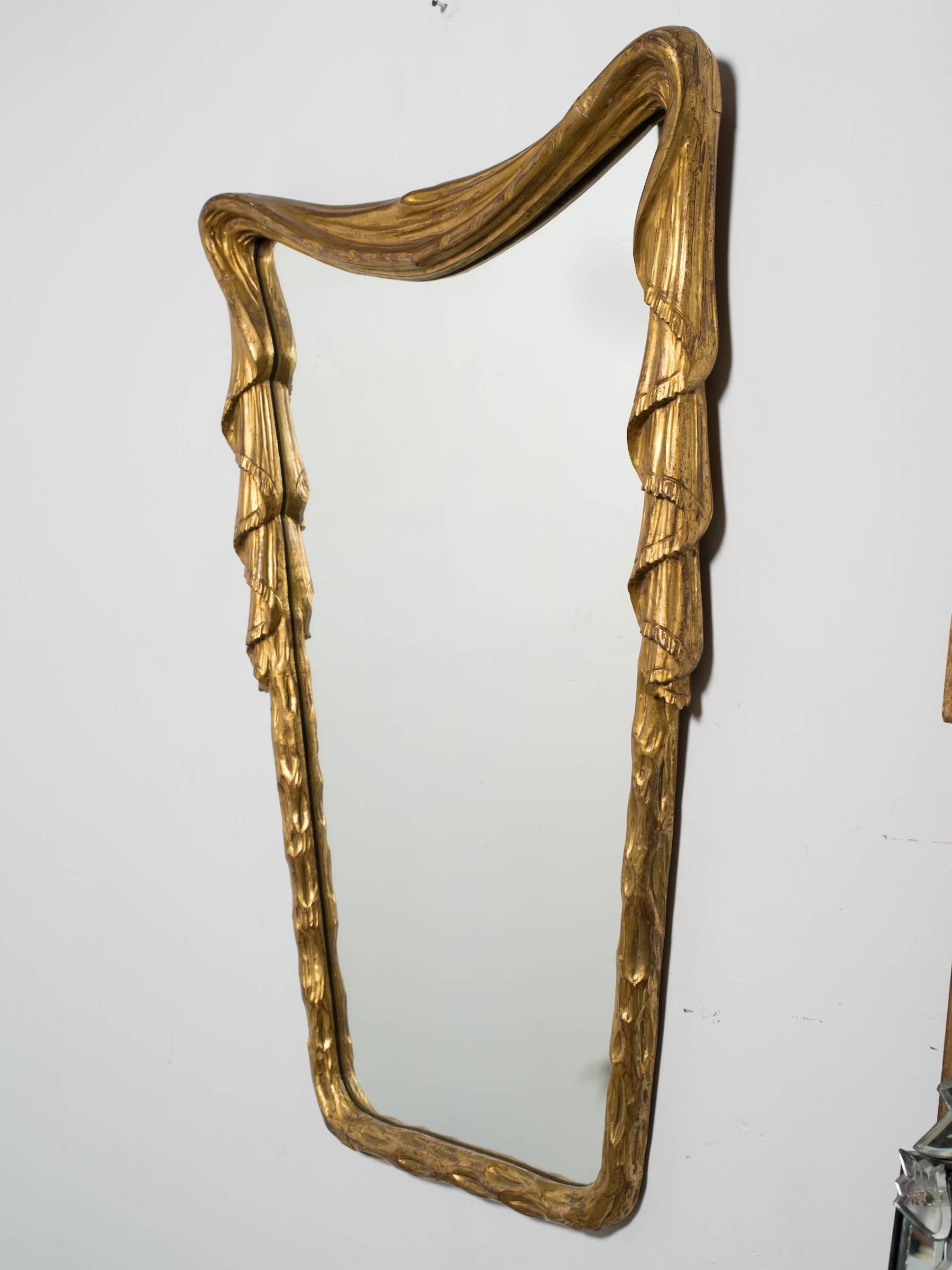 1940s Hollywood Regency carved wood draped mirror from Italy.