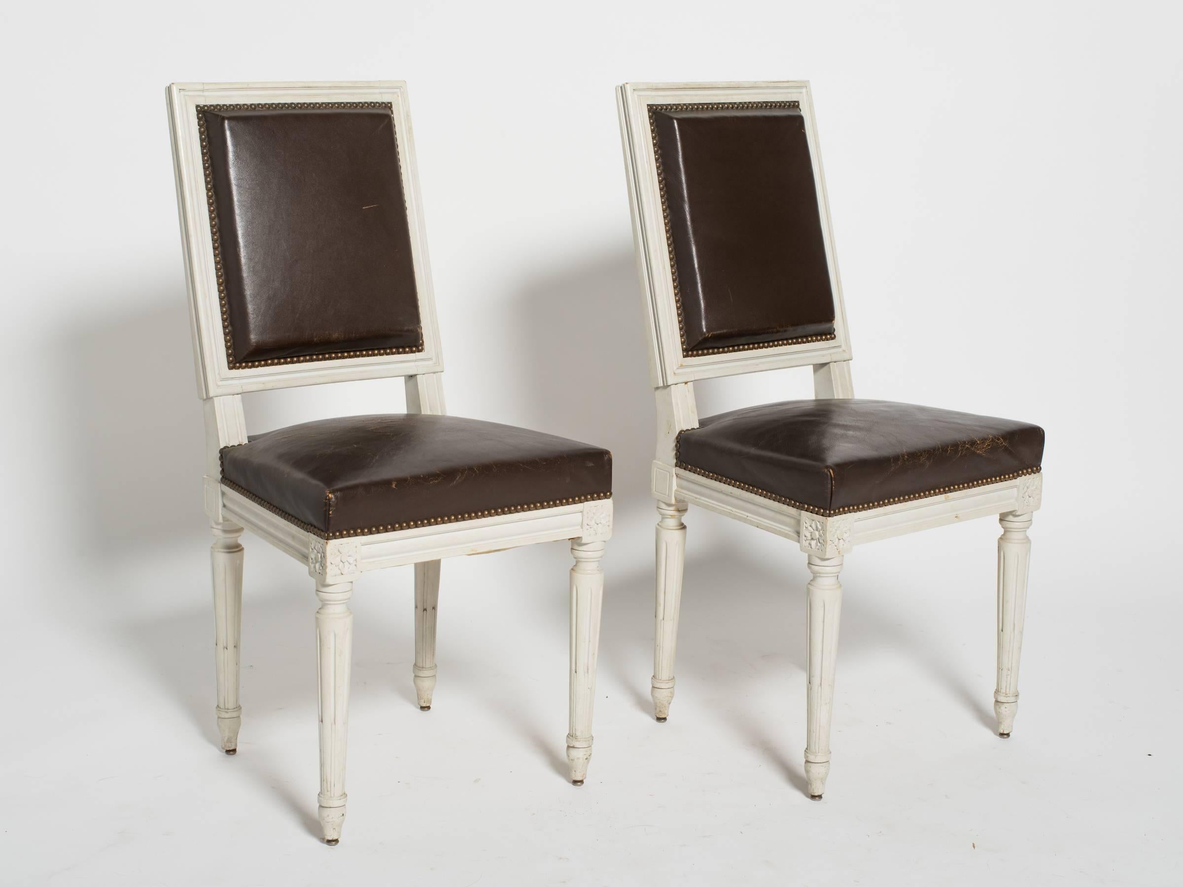 Sold in pairs. Six leather and wood 1920s Louis XVI side chairs from France.