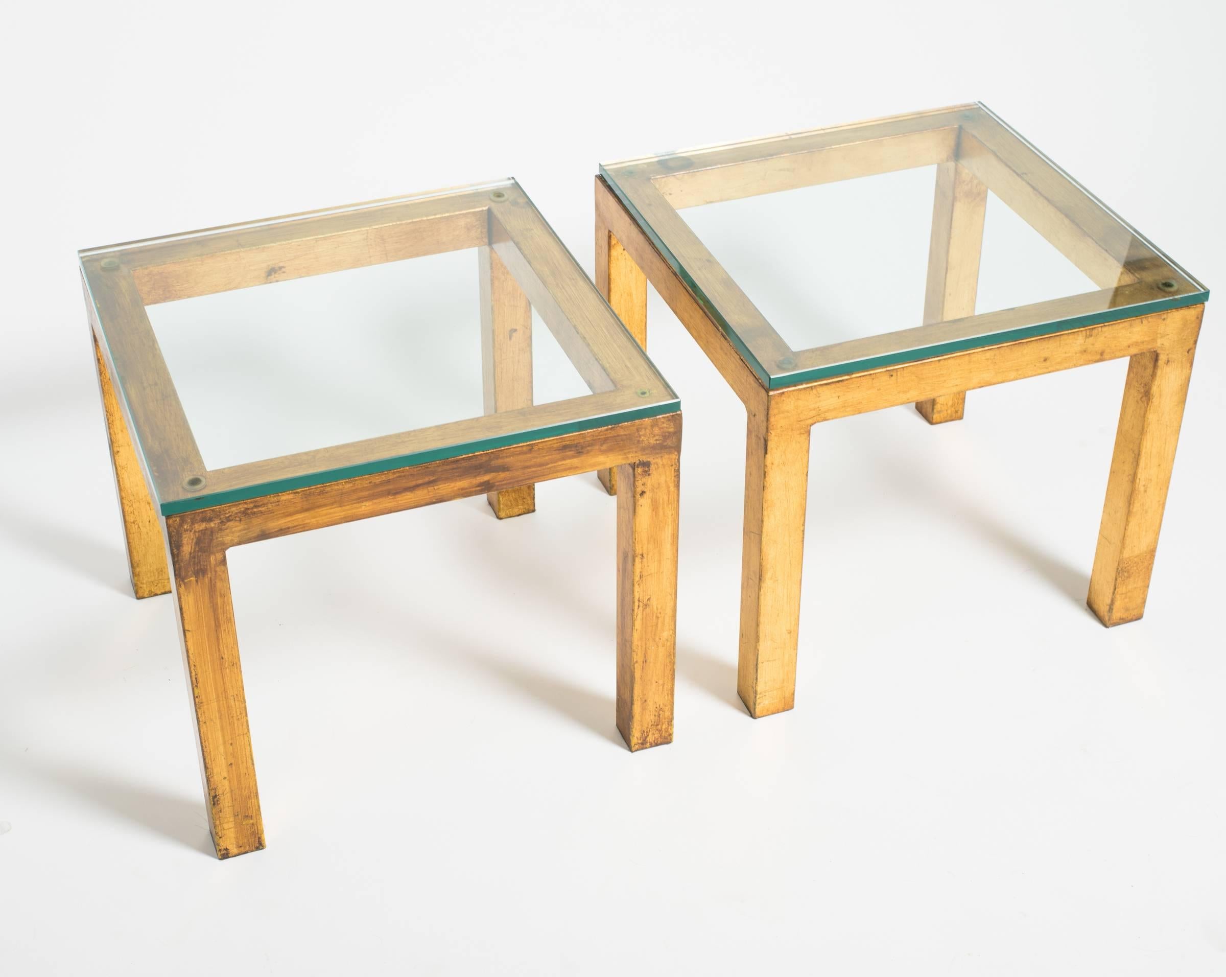 Pair of gilt metal Parsons side tables with thick glass tops from the 1980s.