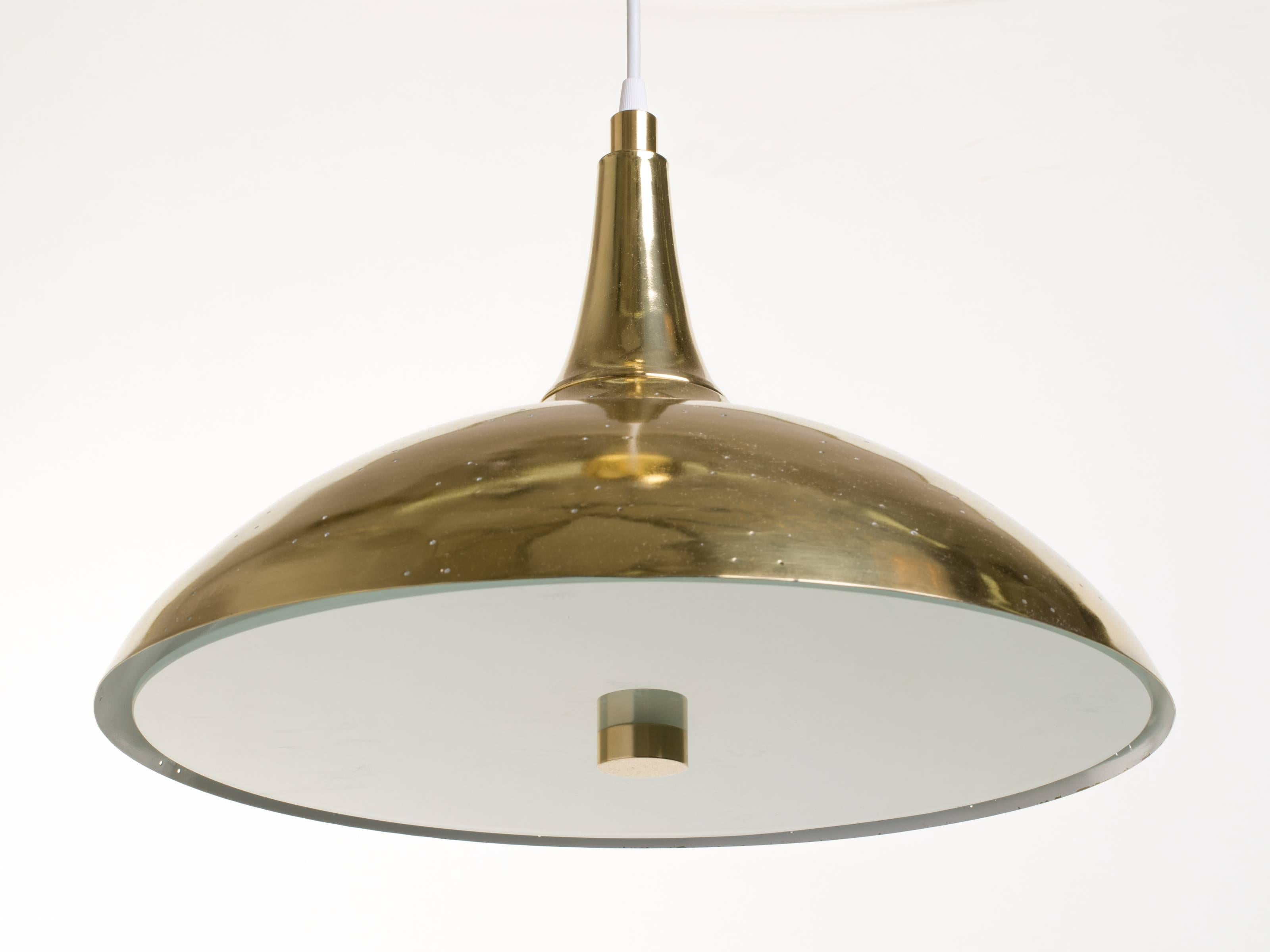 Brass and frosted glass lights with perforated brass shade. Can be sold individually.
Beautiful effect when the light passes through metal shade. Down light is very soft due to the frosted glass diffuser.
Four candelabra sockets. 
Height can be