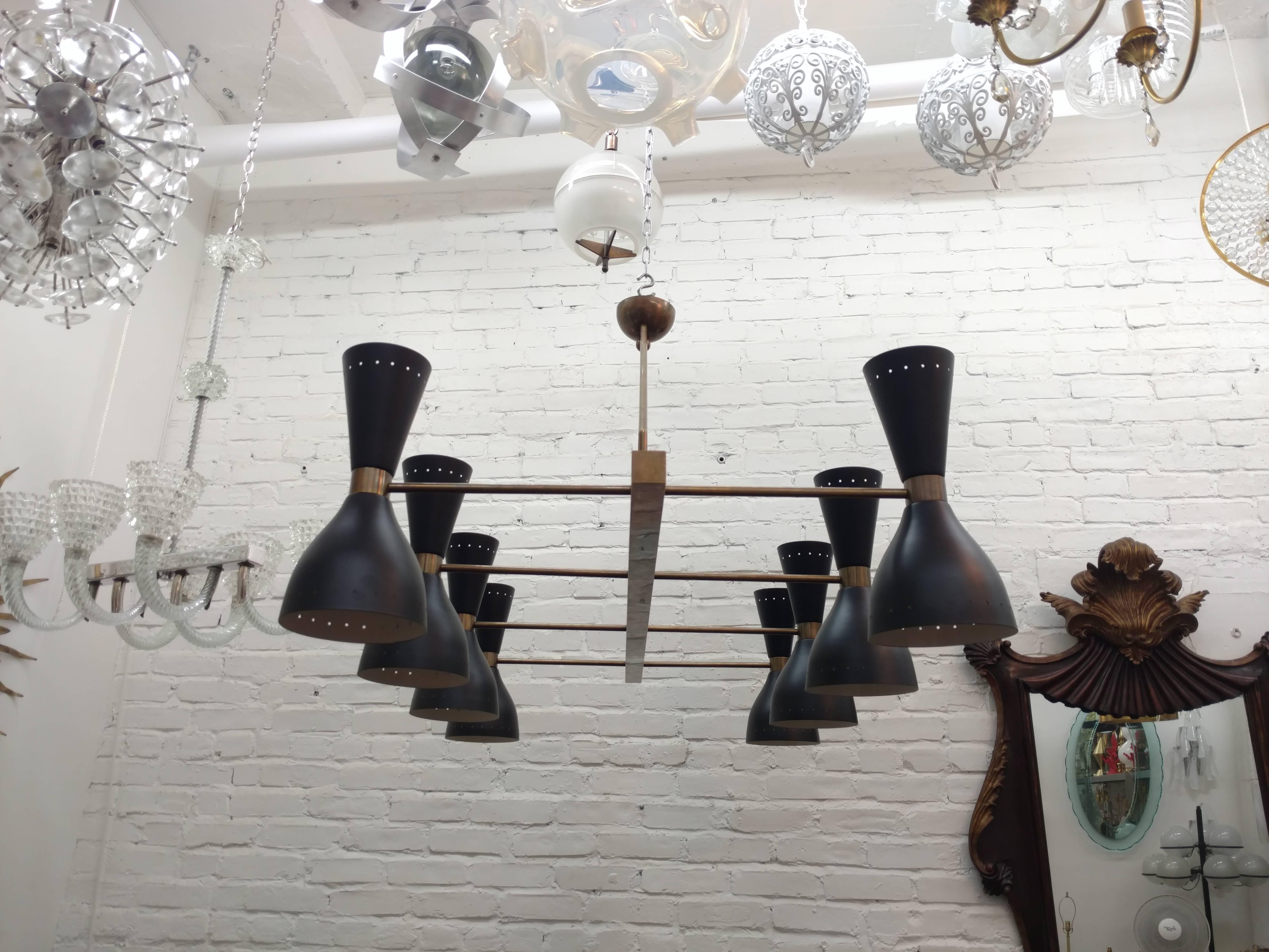 Large made to order contemporary fixture composed of ten satin black enameled shades.
Each fitted with a set of candelabra socket (upwards) and a medium base Edison socket (downwards).