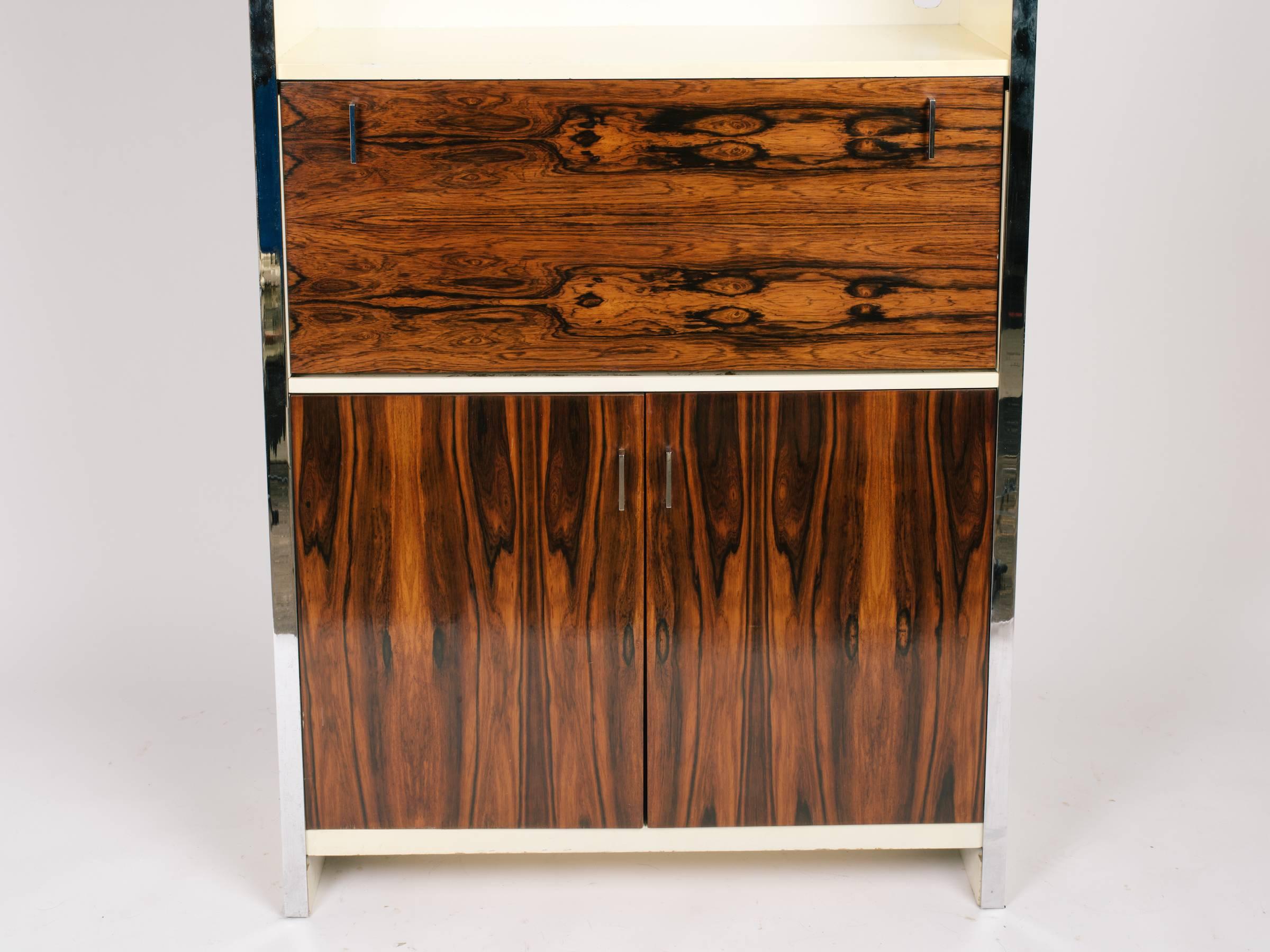1970s John Stuart cabinet. Rosewood doors, chrome trim. Has a pull down door used either for a desk, or a bar.
