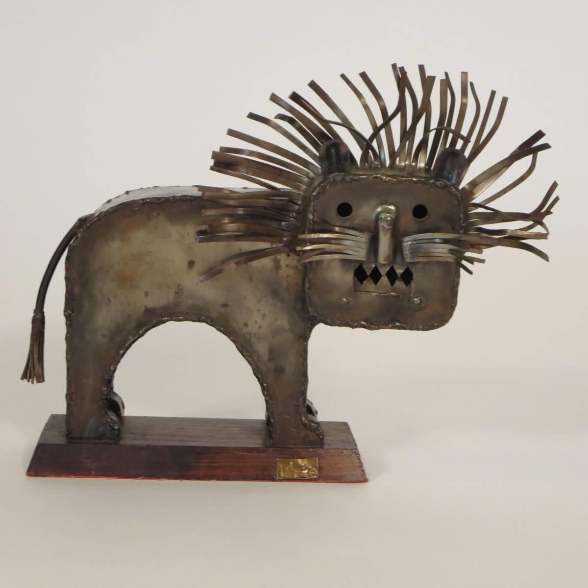 1970s signed metal lion sculpture on wood base.