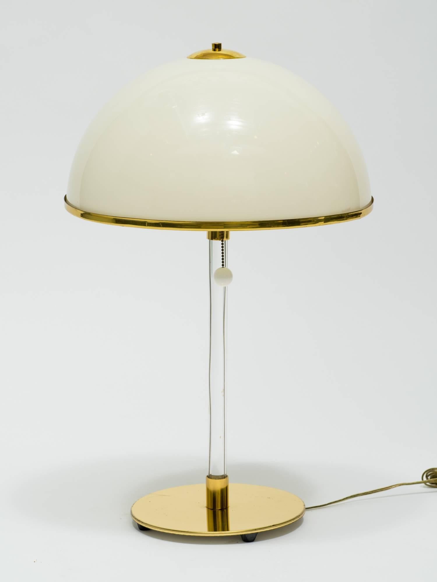 Super chic 1970s Lucite lamps with plastic mushroom shades on a brass base.