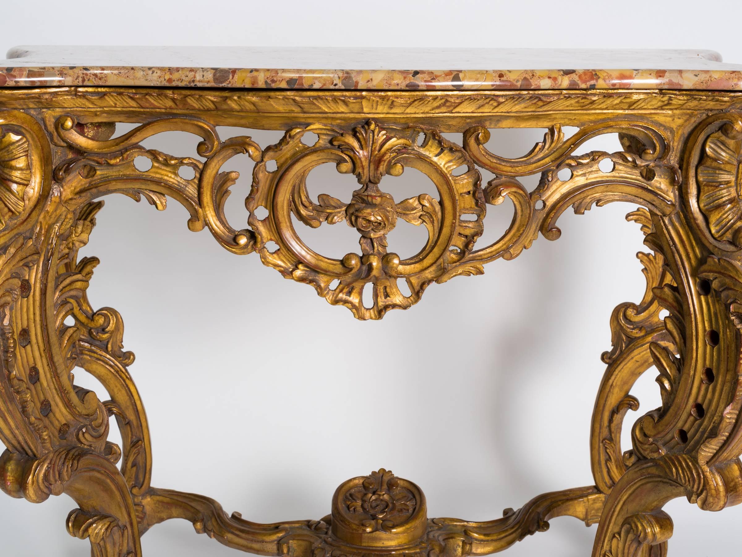 Ornately carved giltwood marble top console.