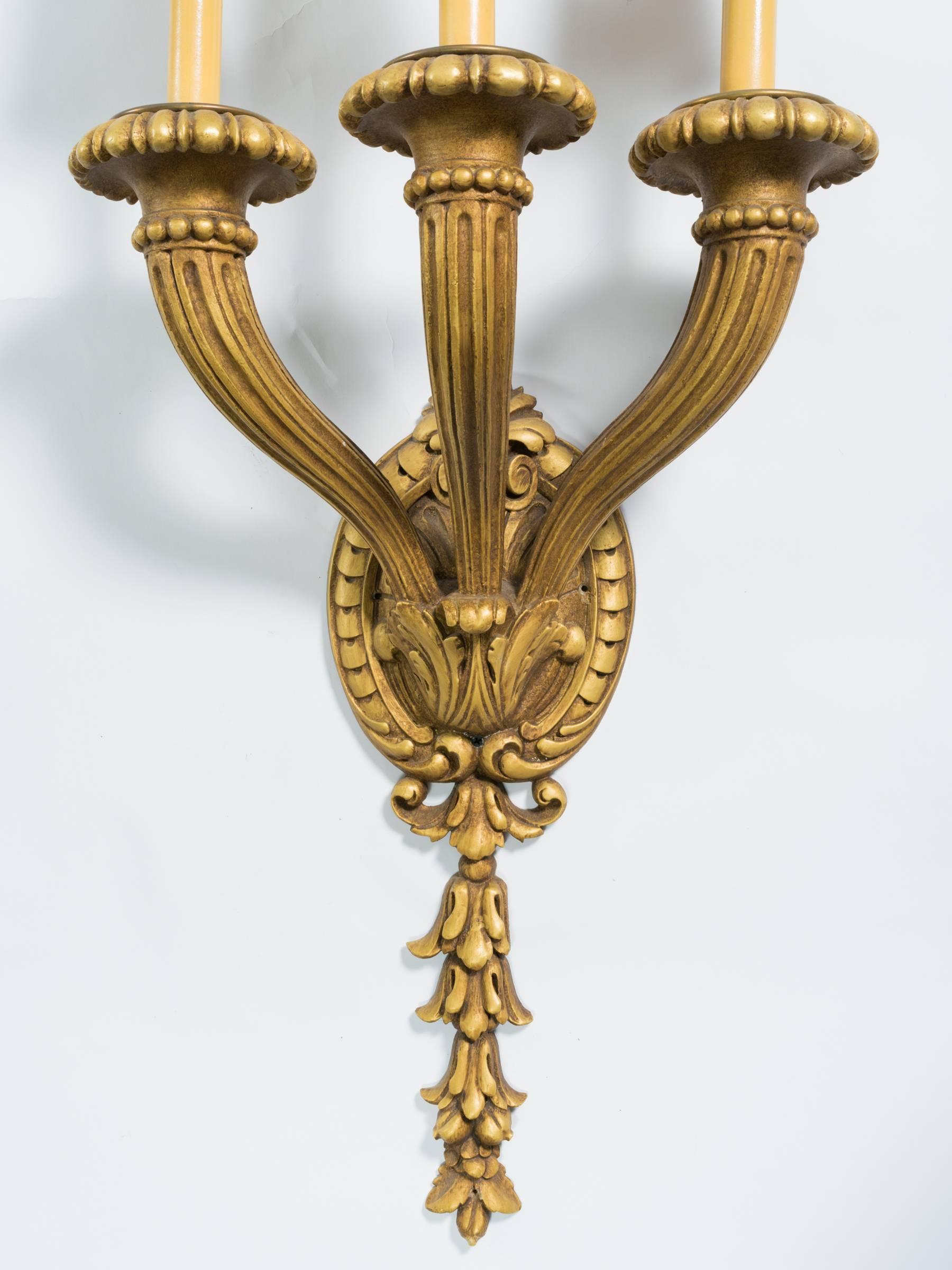 Three-arm French style carved wood gilt sconces, out of a Westchester, NY castle.

Six available

Measures: Candle is 6 inches.