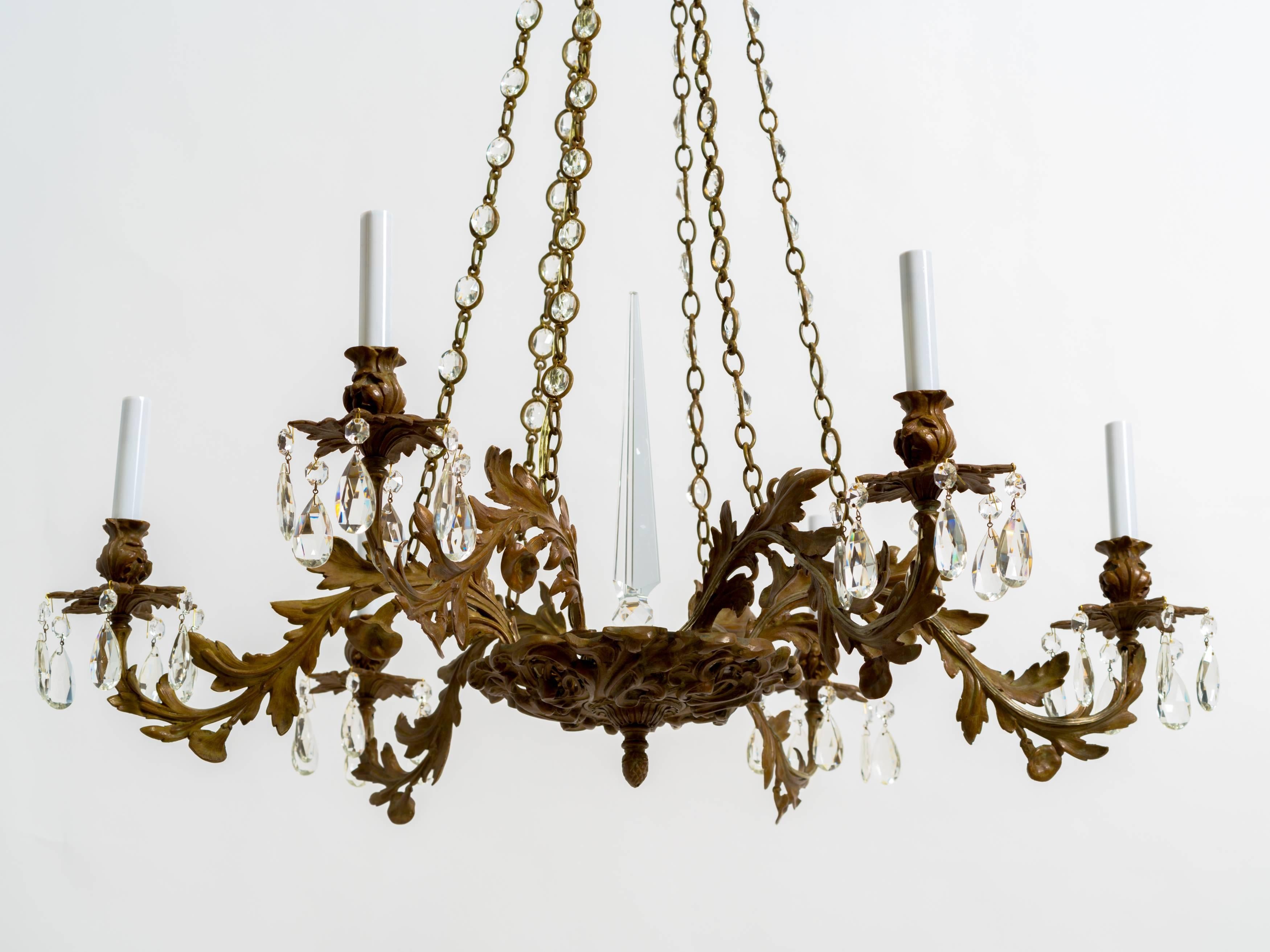 A fine late 19th century bronze nine-light chandelier with acanthus leaves design on arms. Beautiful patina.
Faceted glass prisms and obelisk at the centre
A great example of good craftsmanship.
Professionally restored and rewired.
Arms: Max.