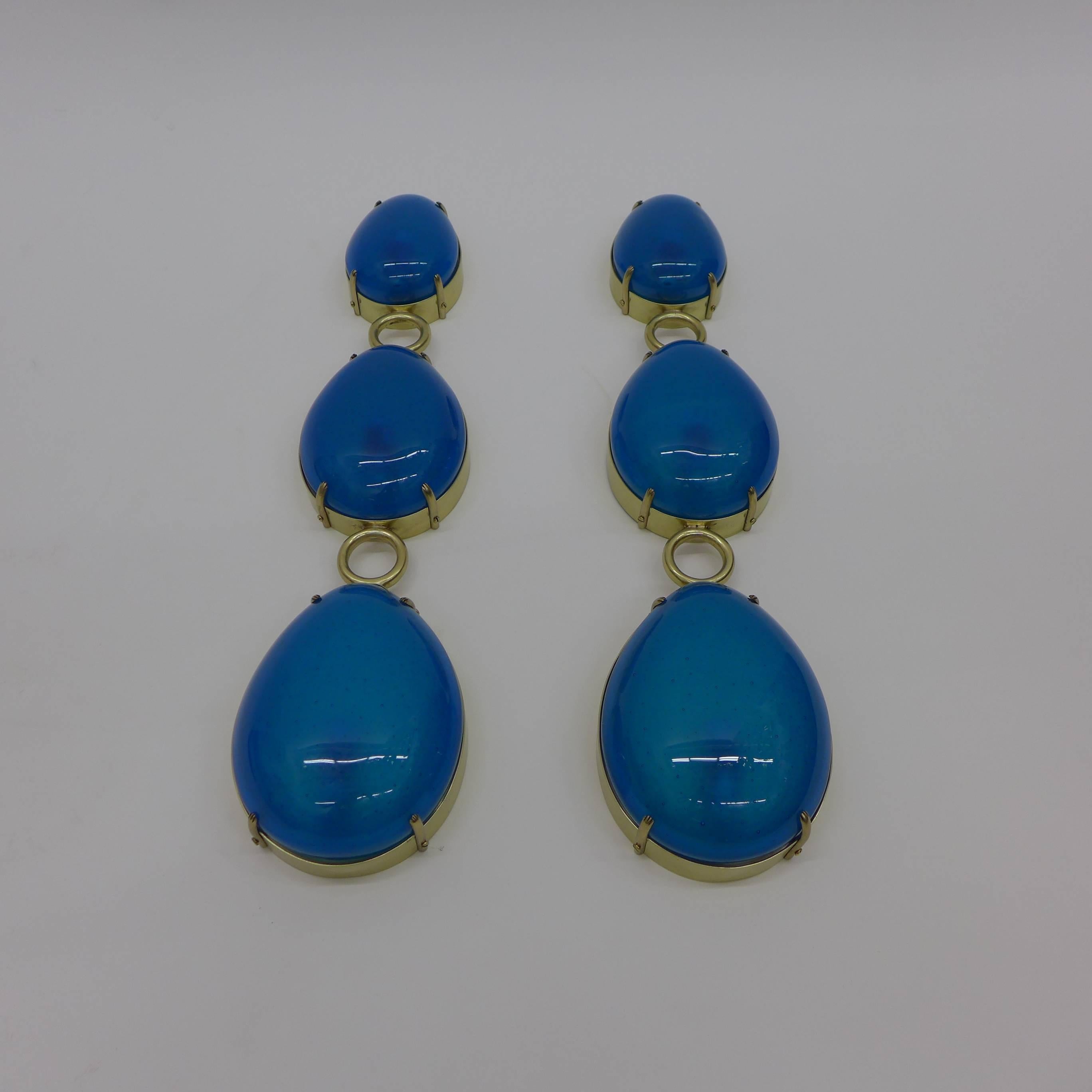 Handmade aquamarine glass and brass sconces.
Limited edition.
Capacity 3 x E12 25 Watts.
