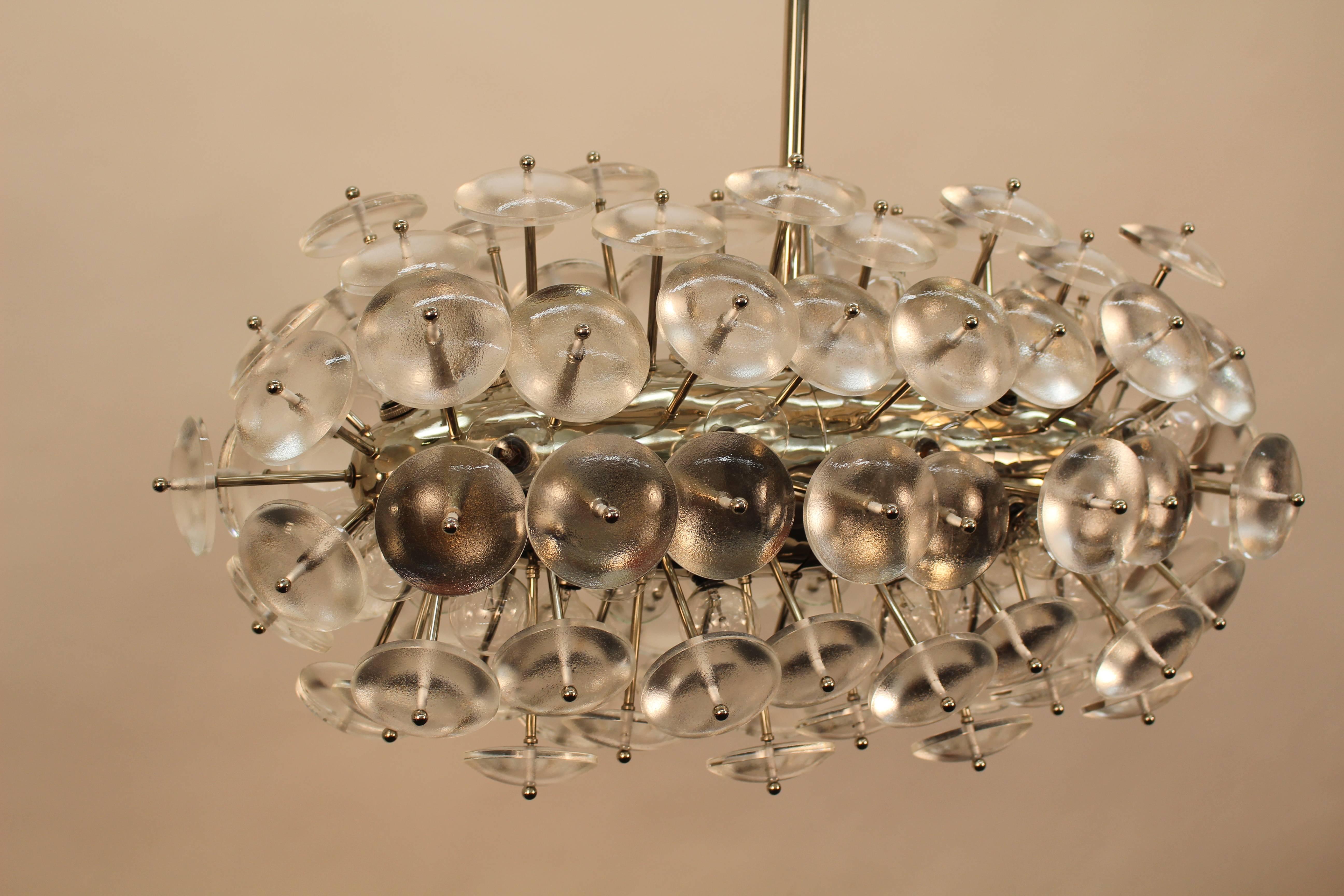 Custom-made Sputnik chandelier composed of thick glass lenses in nickel finish. 32 sockets inserted on main body.
Max. capacity is 15 watts per socket. Total 480 watts.
Made to order. Brass finish available.