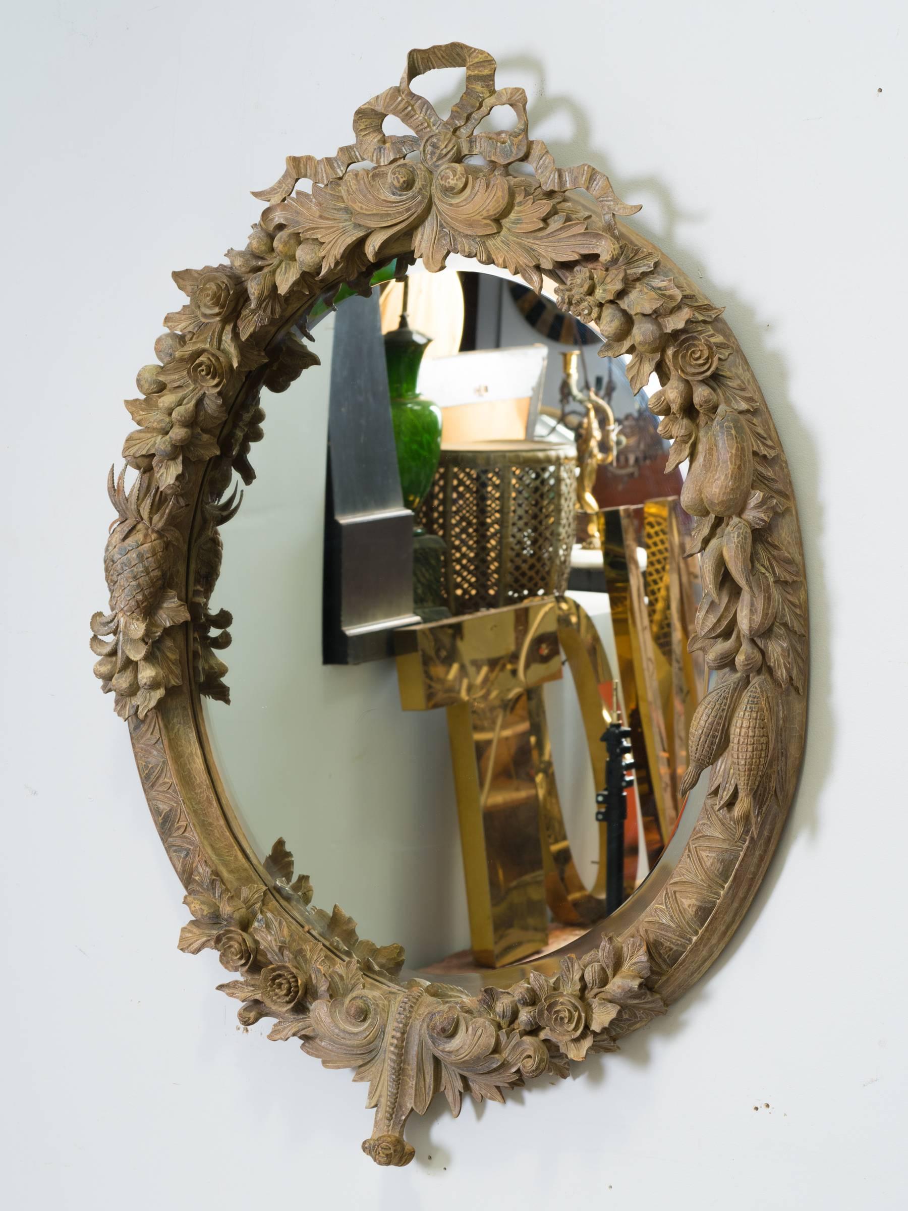 Carved wood mirror with fruit and floral motif designed by John Richard.