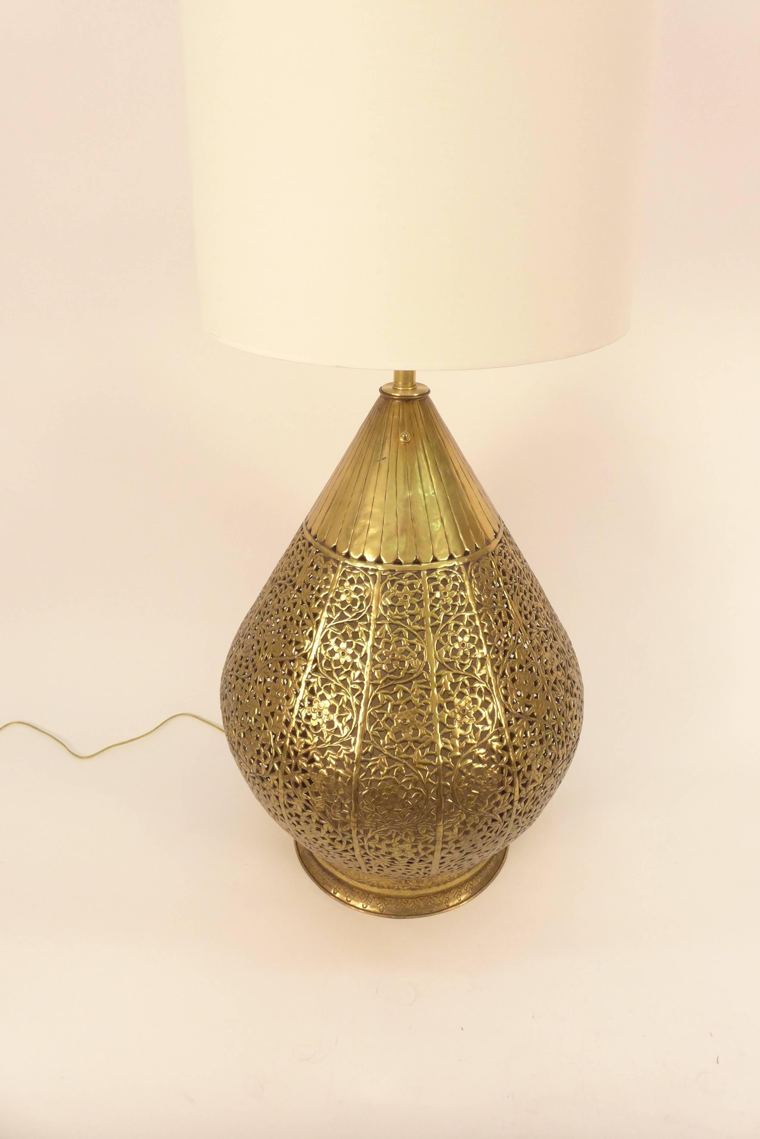 Very large brass lamp with Asian design.
It has a three way switch so it can be lit at the base, top or both together.