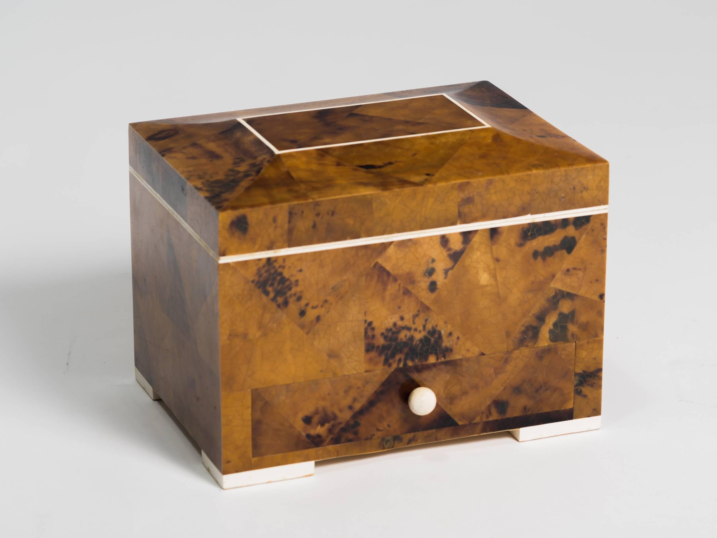 Stone jewelry box in a burl wood design.