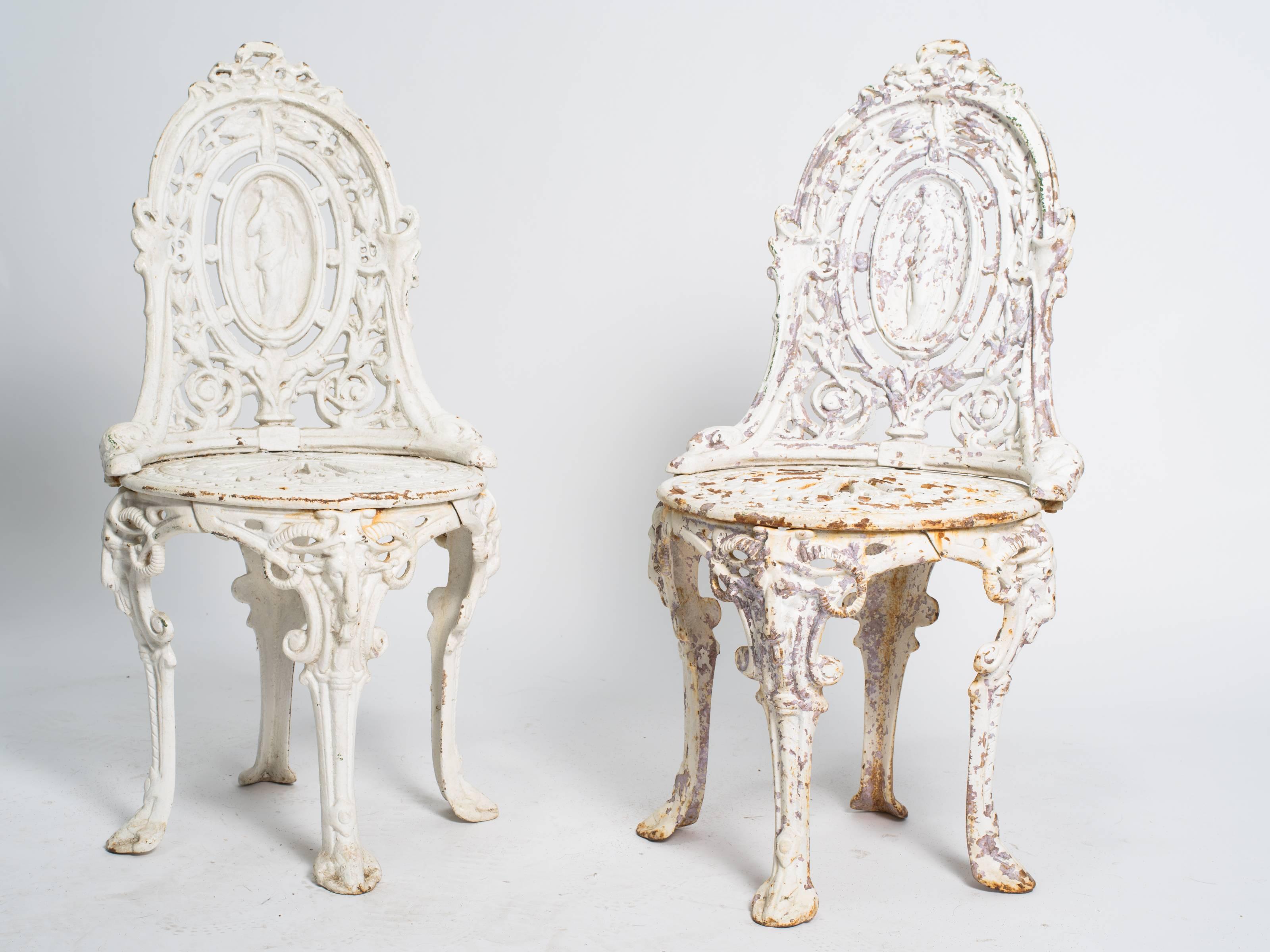 Early 20th century English garden chairs. Made of cast iron with some paint loss. We have three available.