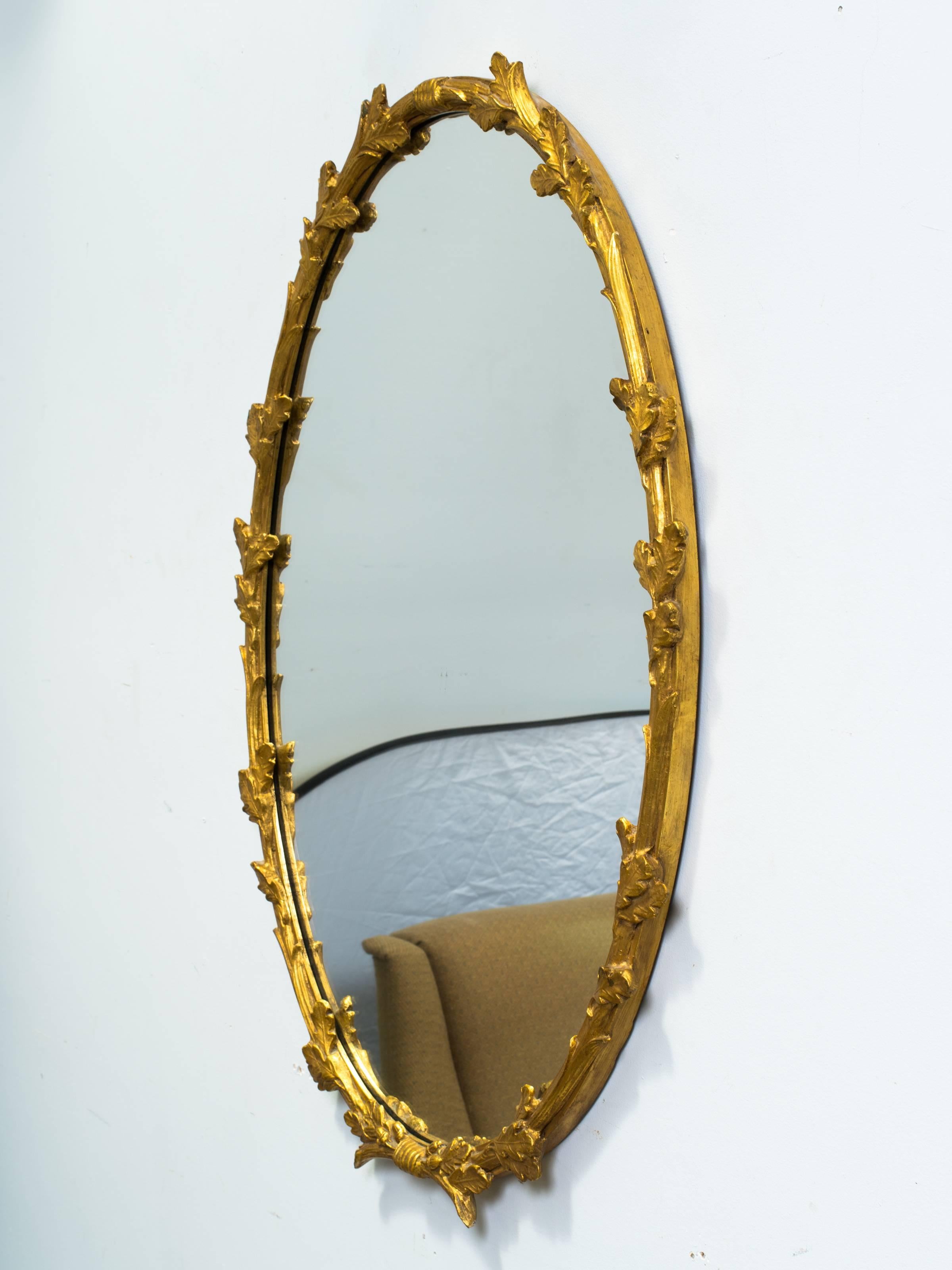 Giltwood floral wall mirror by Friedman Brothers.