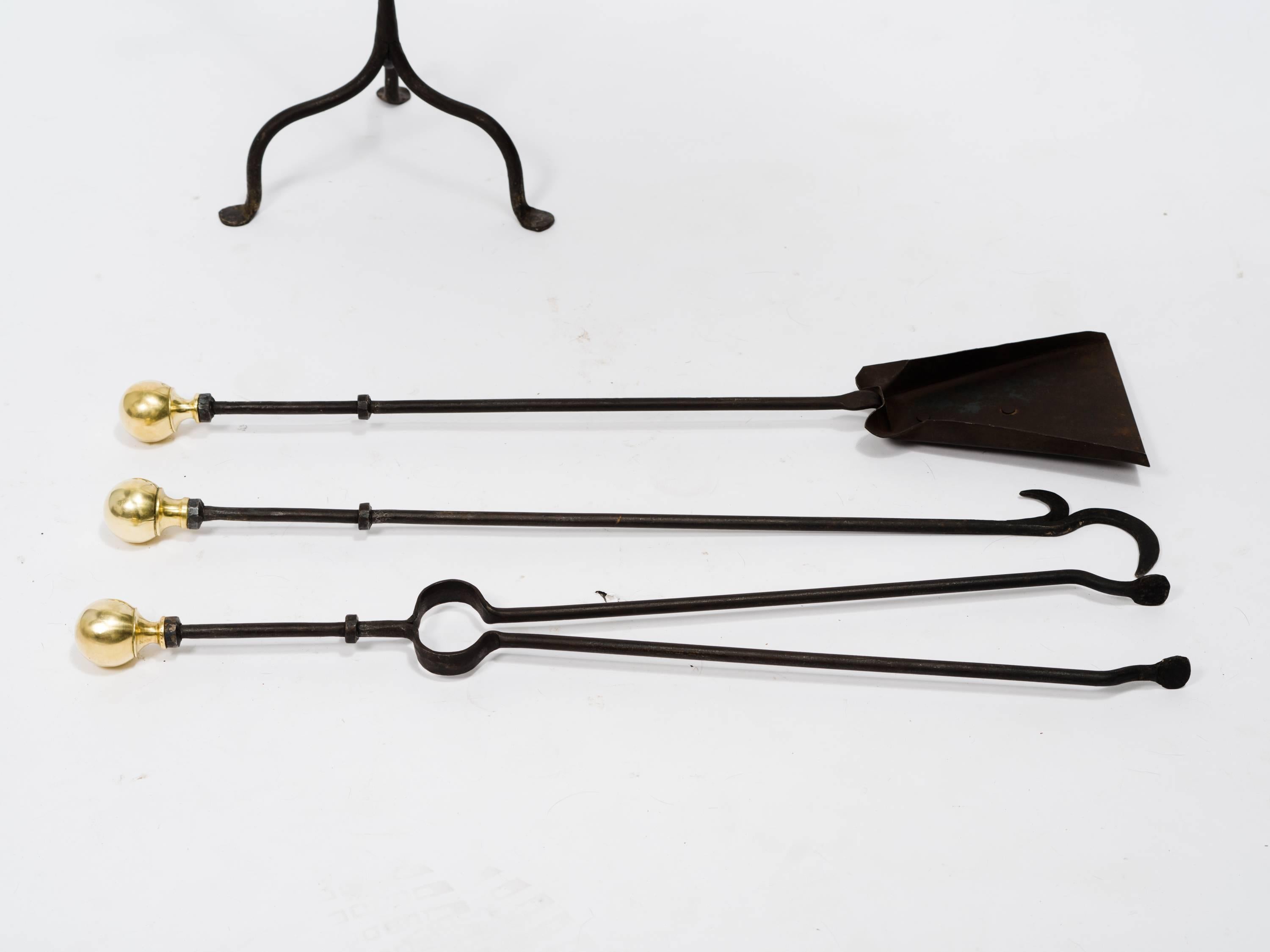 Set of antique brass and iron fireplace tools.