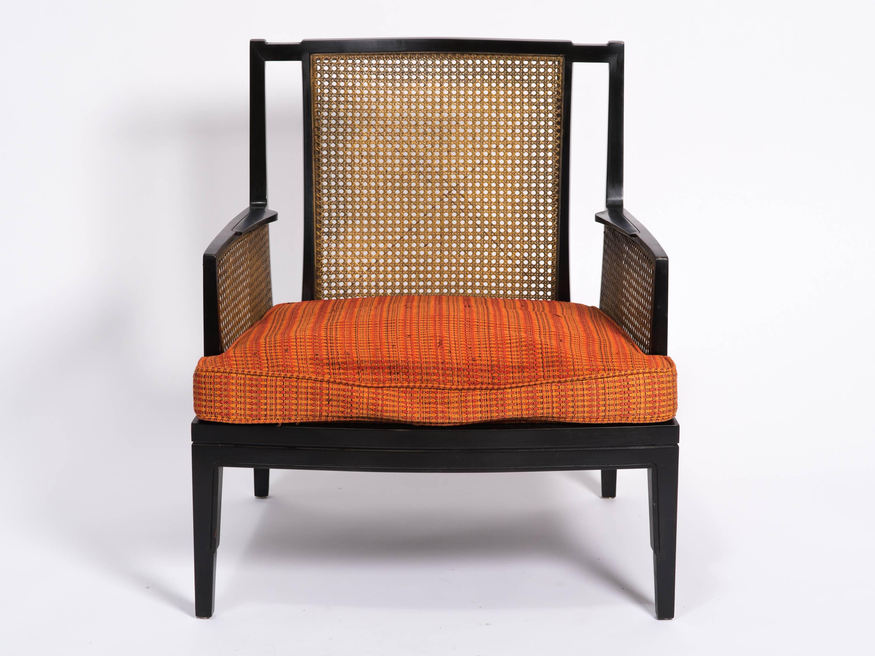 Pair of Art Deco caned lounge chairs. Lacquered black with caned sides and back. Original cushion has to be changed.