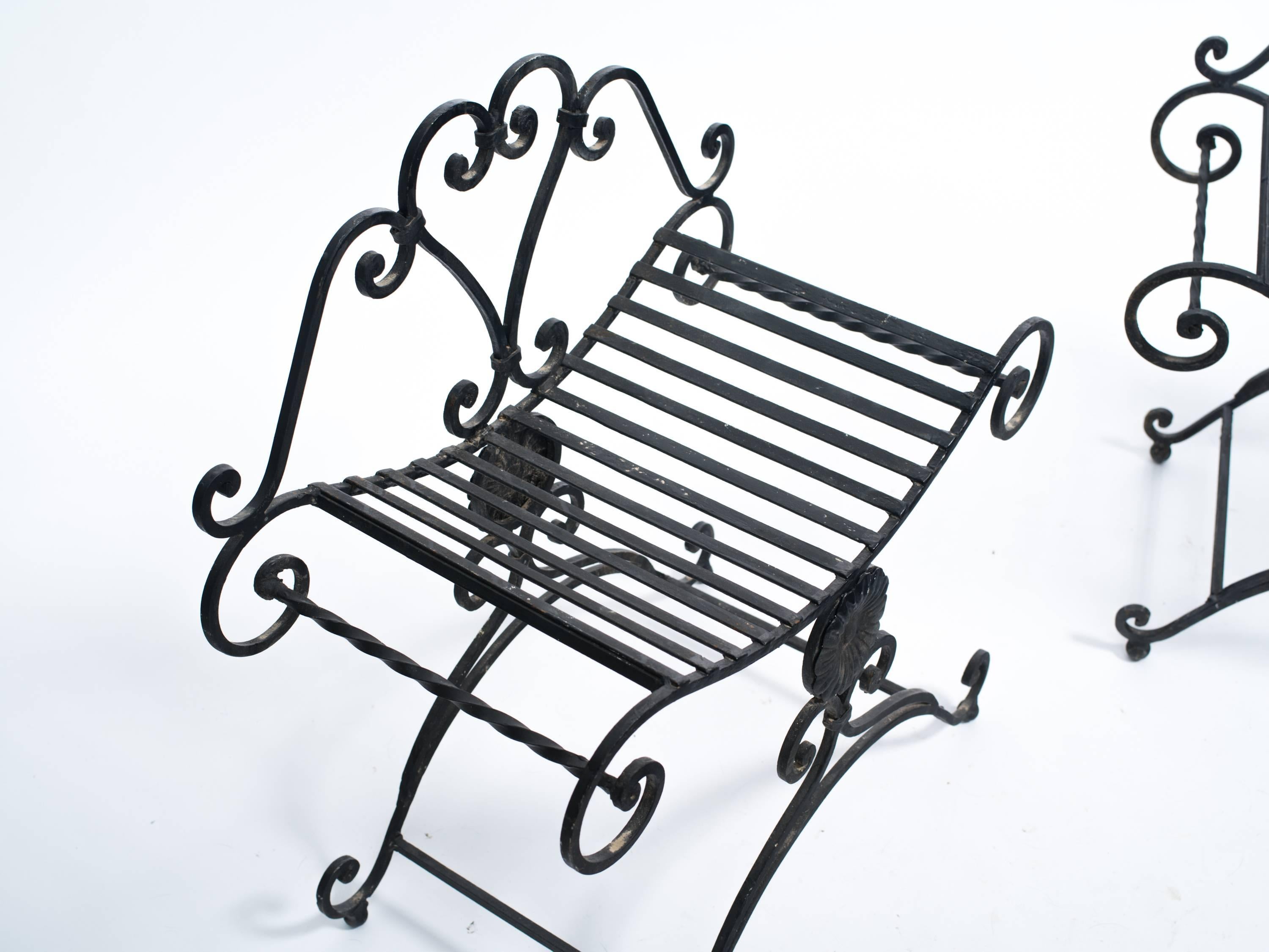 Two classical iron benches.