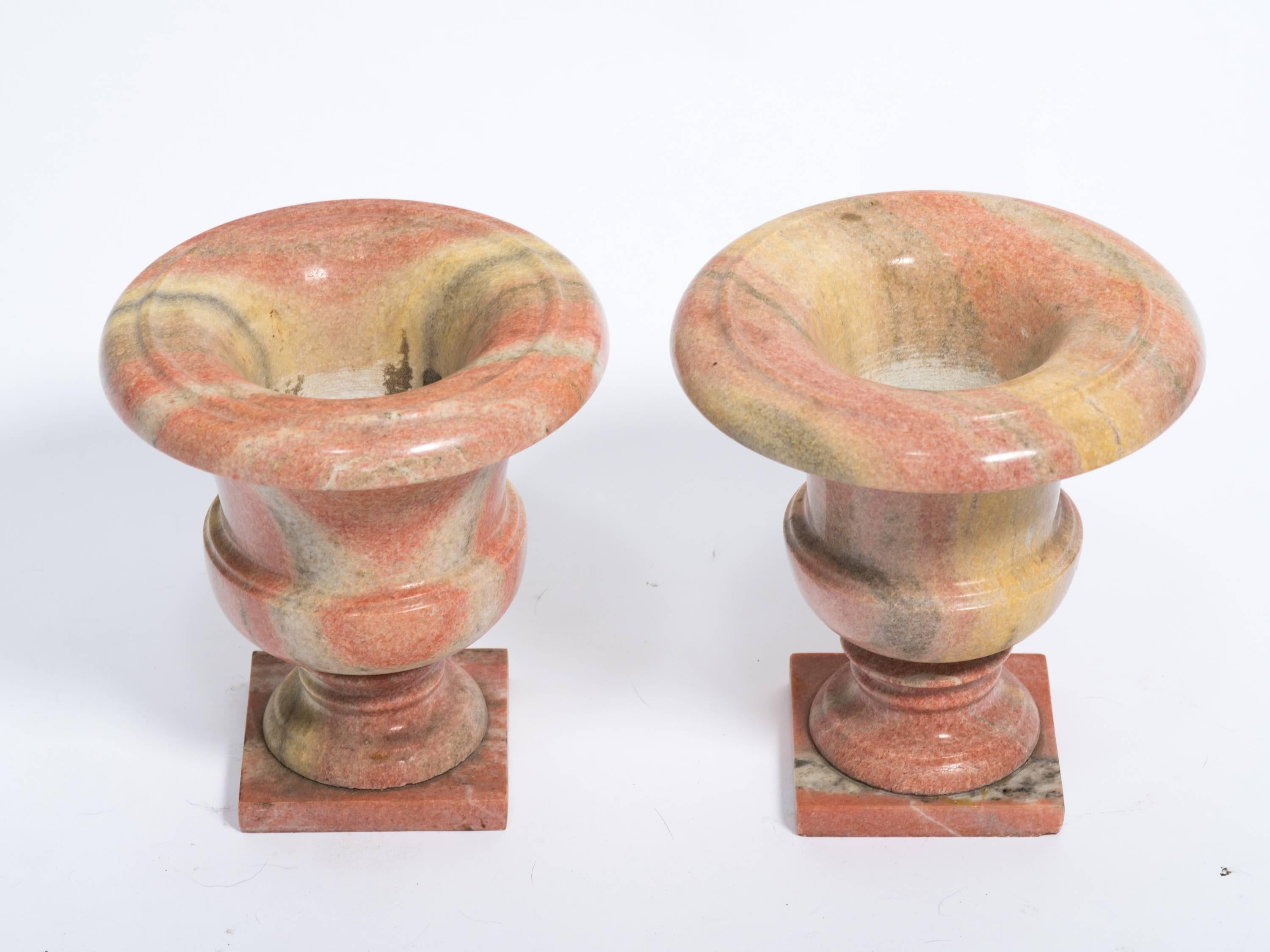 Two handmade marble urns or planters.