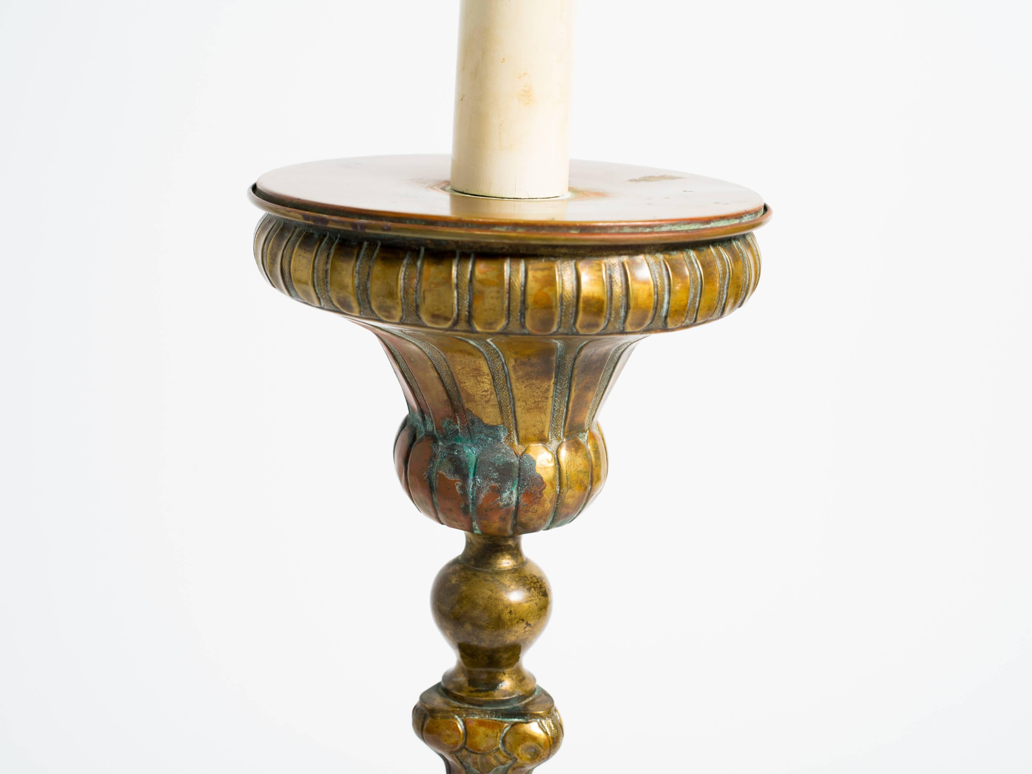 Large brass candlestick lamp.