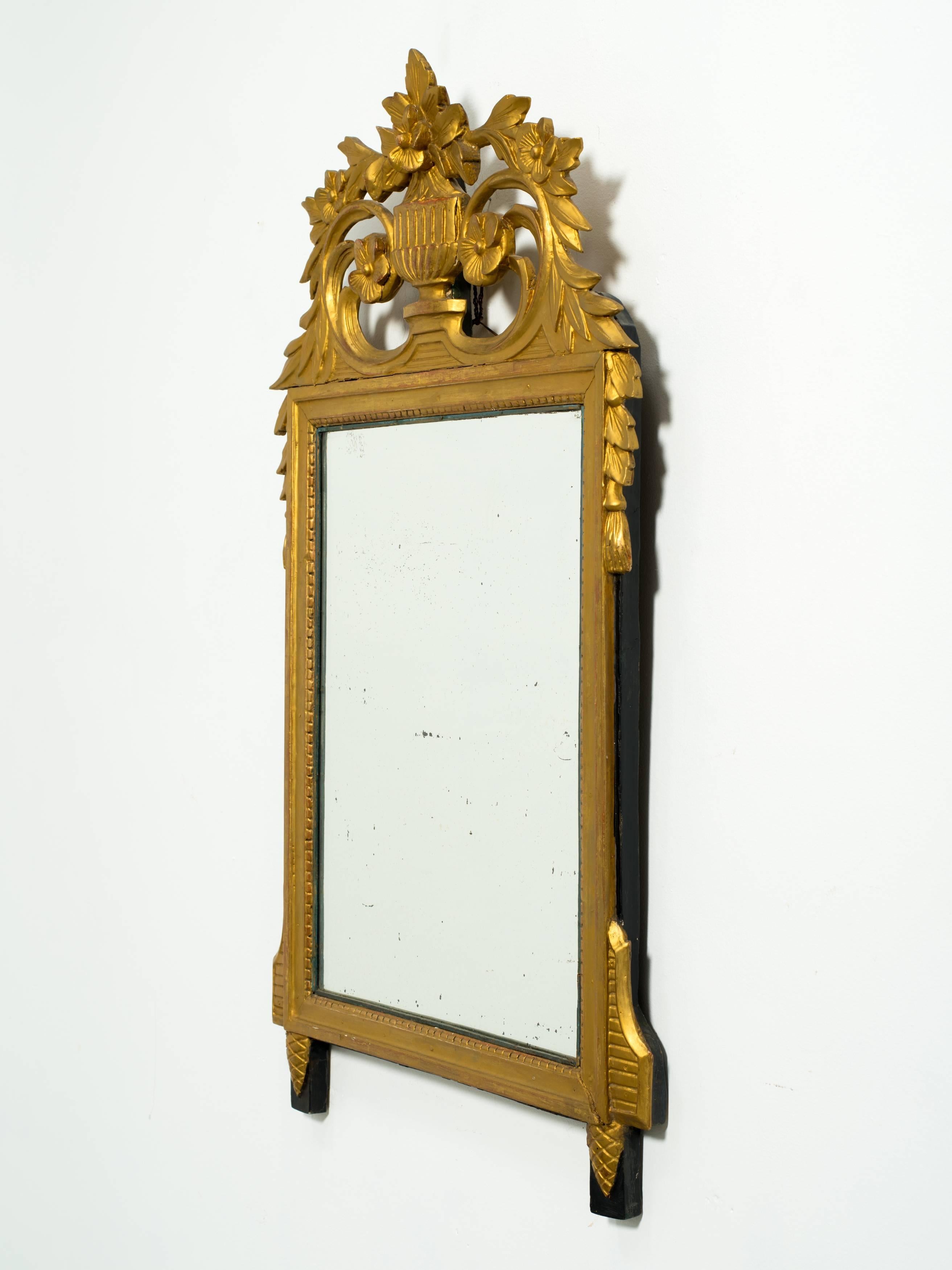 Carved giltwood French wall mirror.