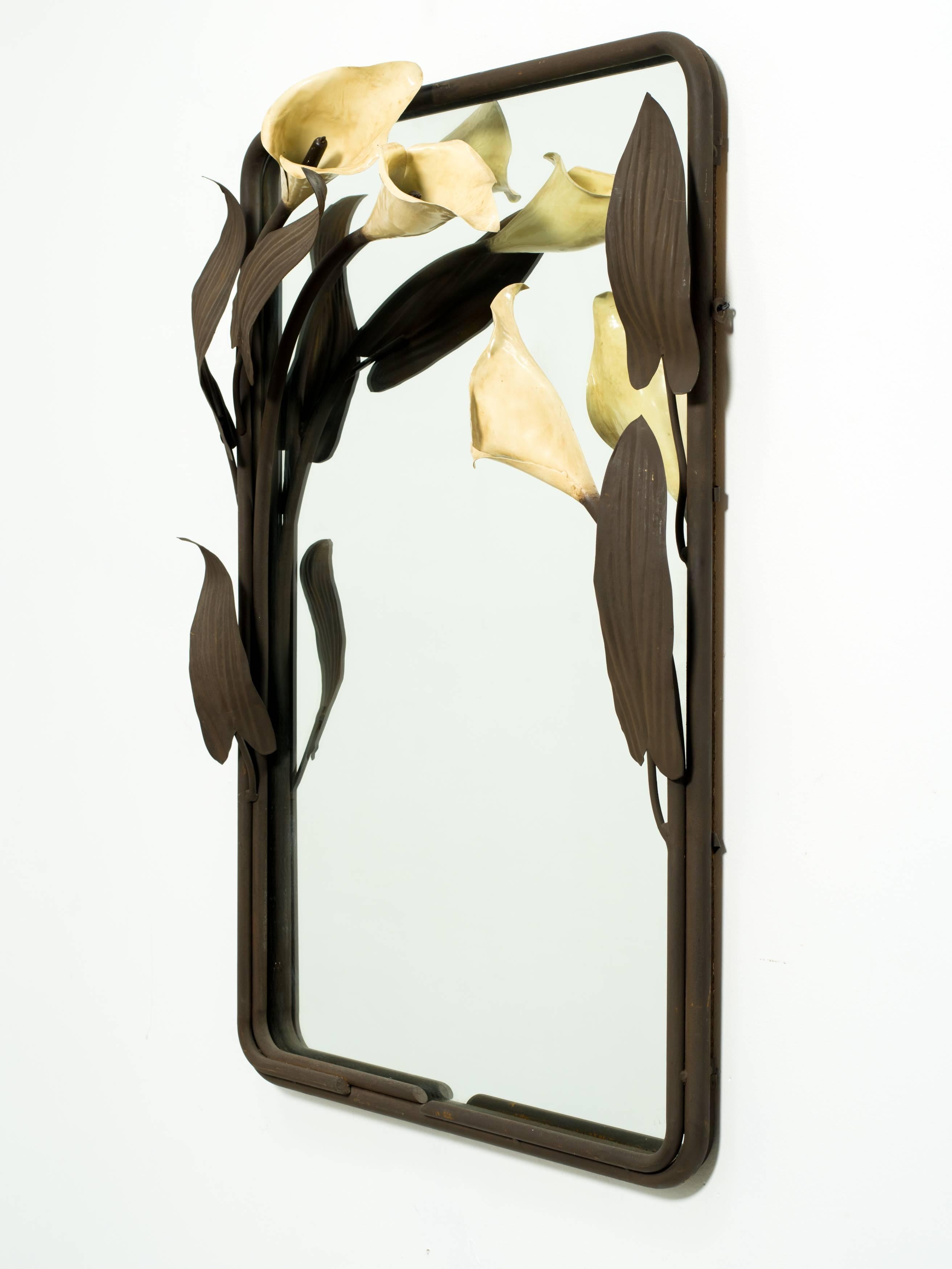 Mid-Century Calla Lily wall mirror. The flowers are enameled with painted leaves and frame. Mirror is metal.