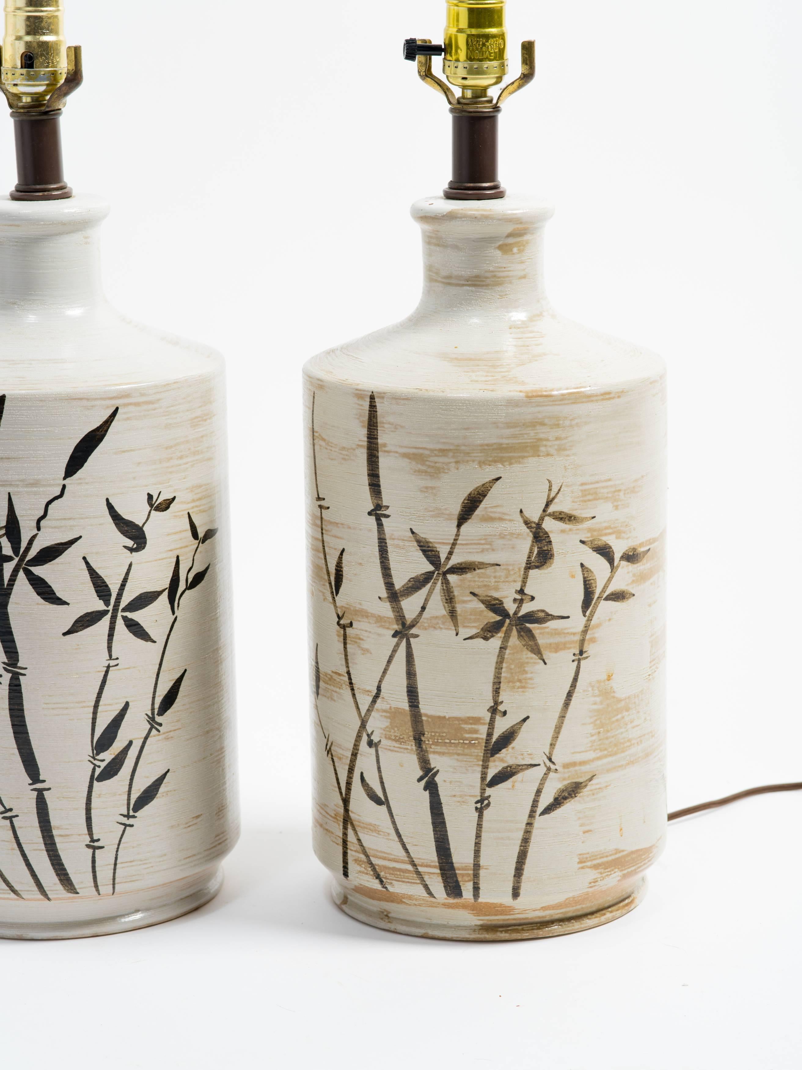 Pair of ceramic table lamps with painted bamboo trees.