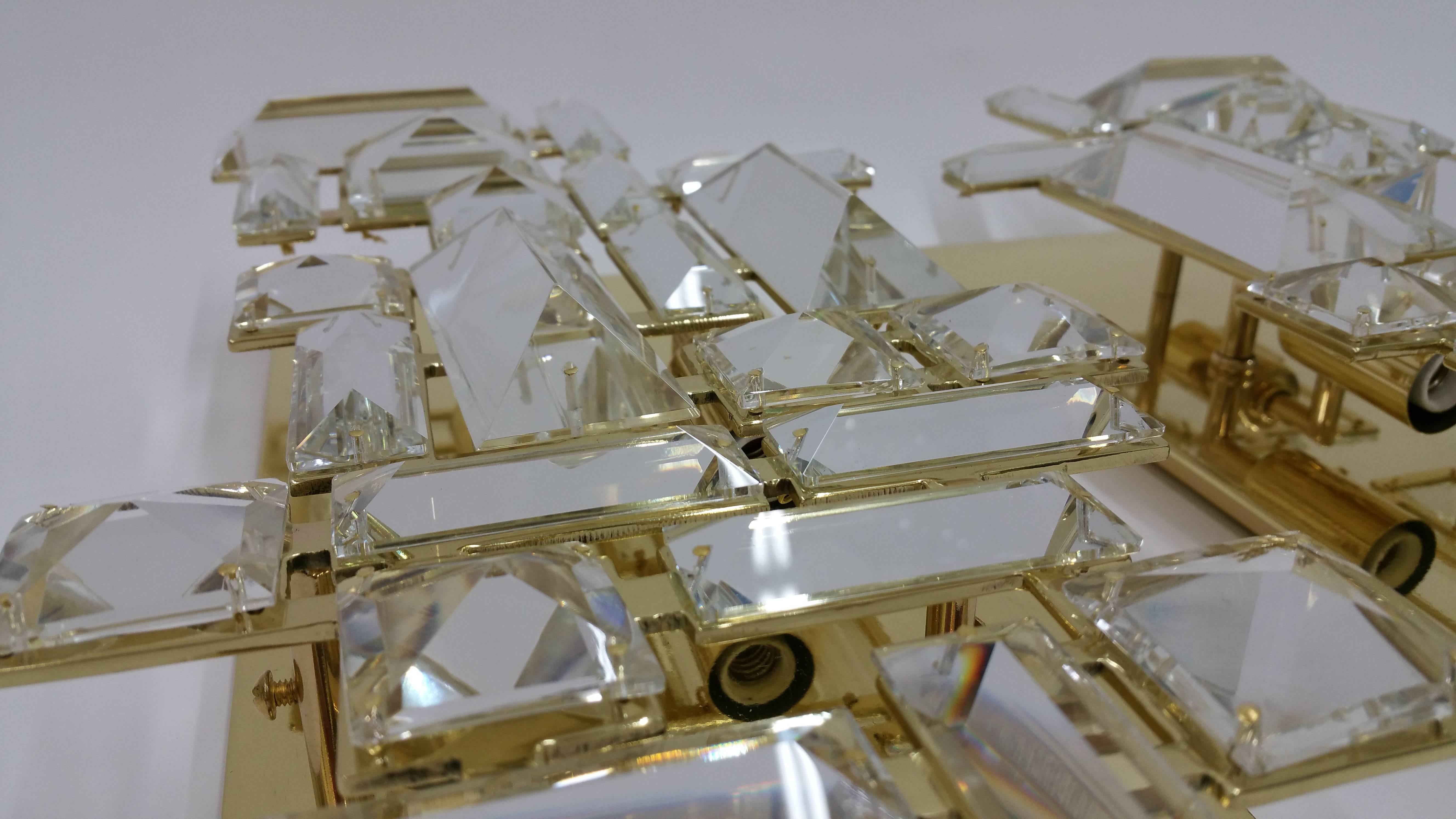 Brass finish sconces with hand-cut crystals.
Three candelabra sockets. 
Max 60 Watts per socket.
 