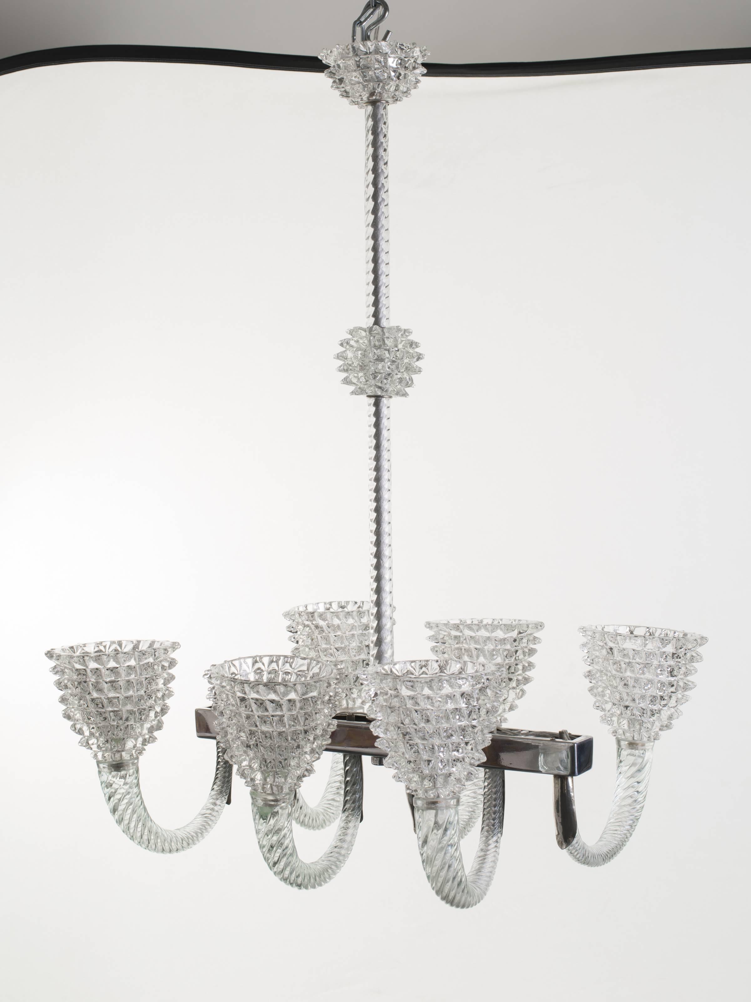Vintage handblown clear glass [rostrato] oblong-shaped chandelier comprised of six lights. Ornate silver fittings and steel structure.

Measures: Stem is 31 in H and it can be shortened upon request.

Ferro Toso Vetrerie. Italy, circa 1940.