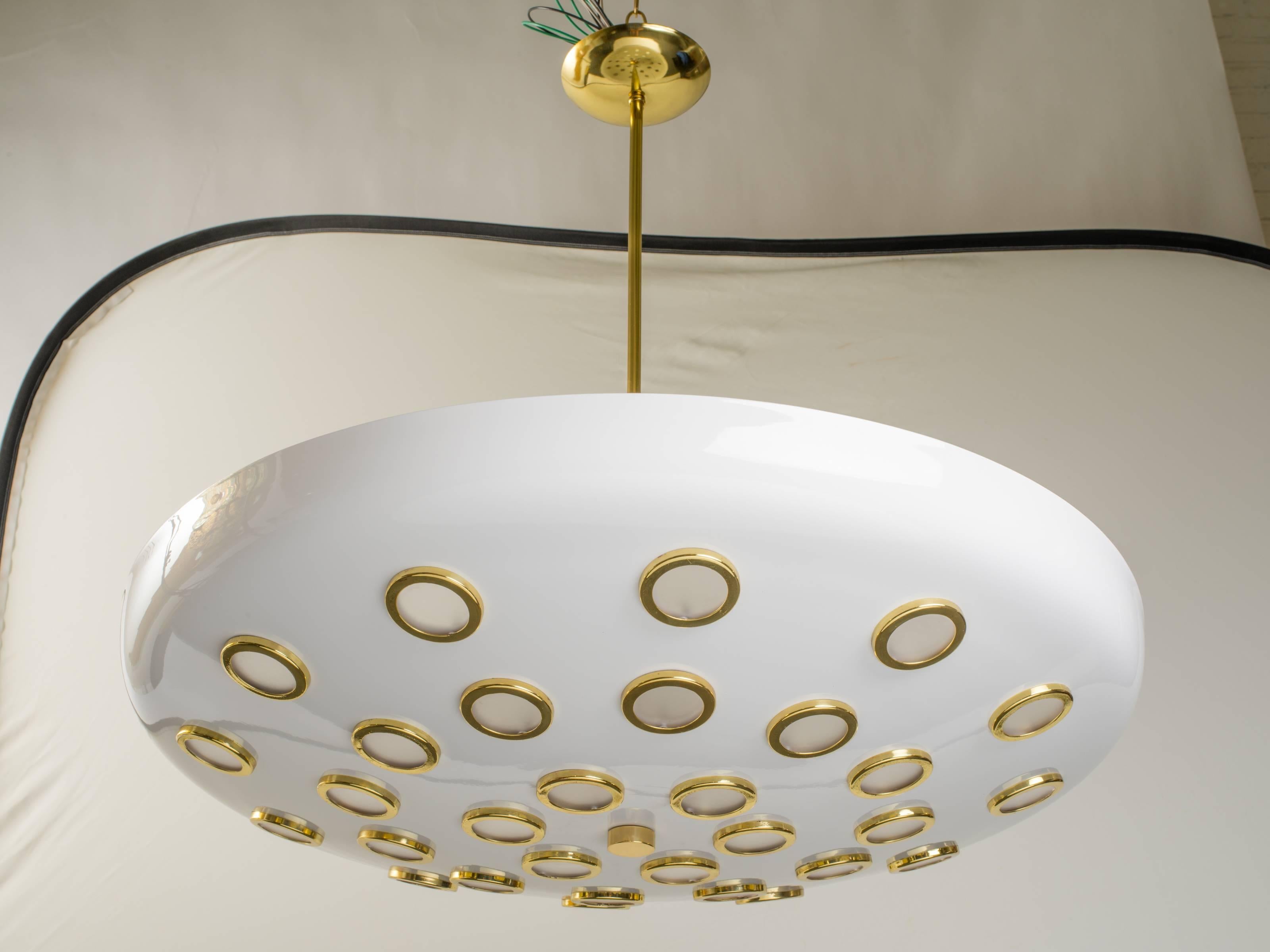 Large flying saucer fixture composed of 30 small frosted lenses and brass rings.
Arredoluce produced these style chandelier in the 1960s.
Dimension: 32