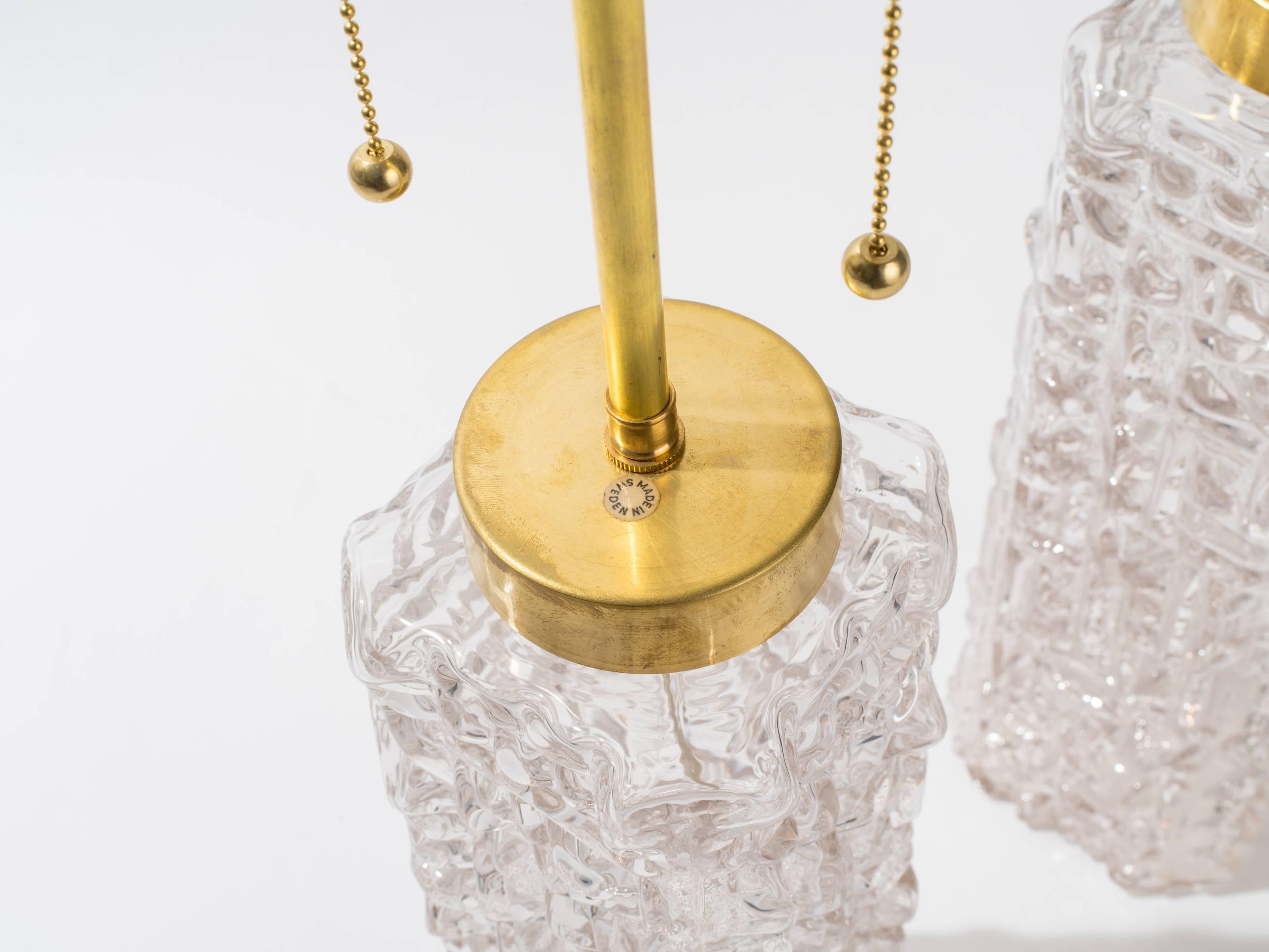 Unusual pair of molded glass table lamps by Carl Fagerlund.
Lamps were professionally restored with new brass caps and double pull chain socket. Newly wired.