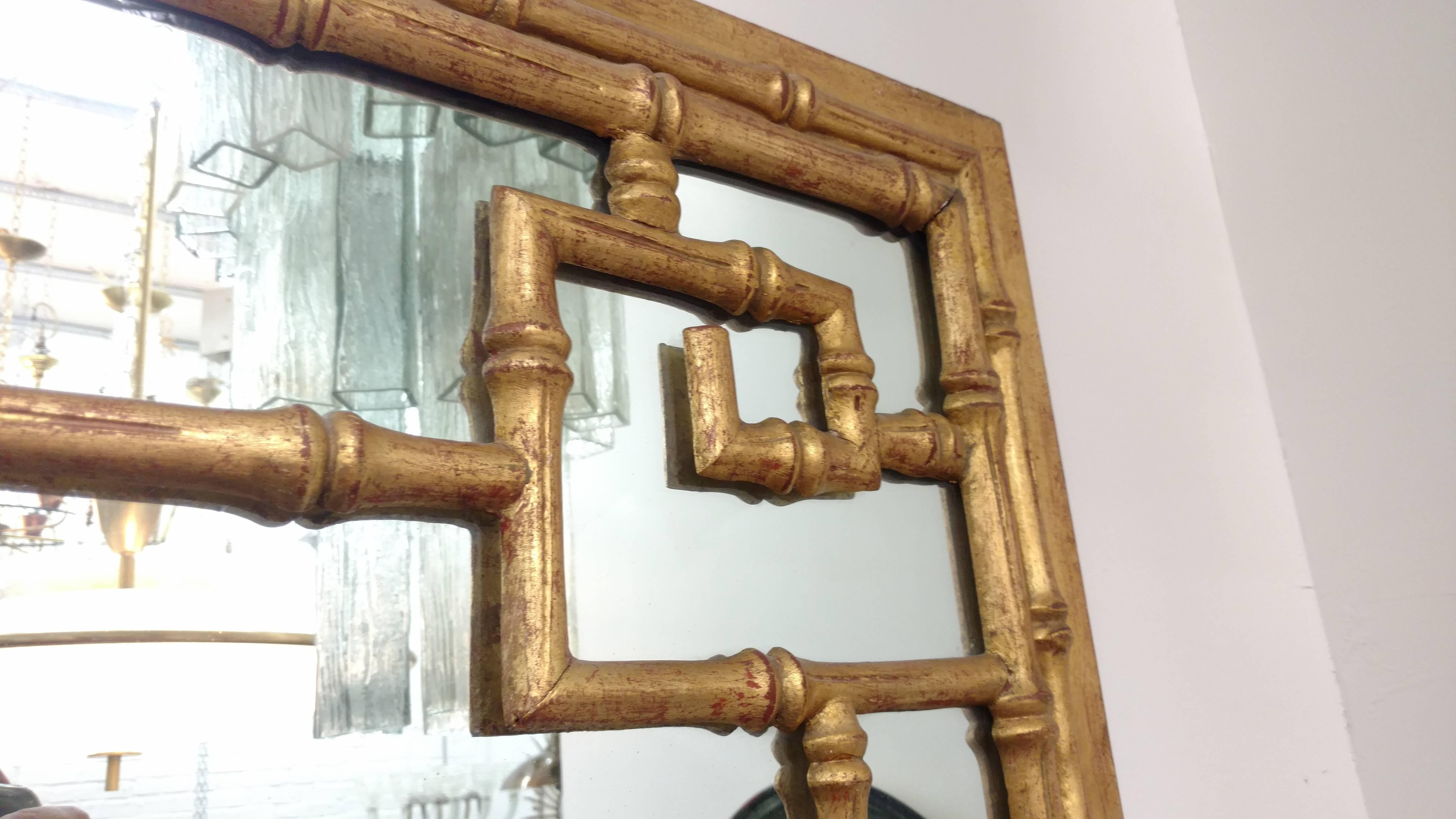 1940s, Italian giltwood chinoiserie mirror featuring a symmetrical Greek key motif.