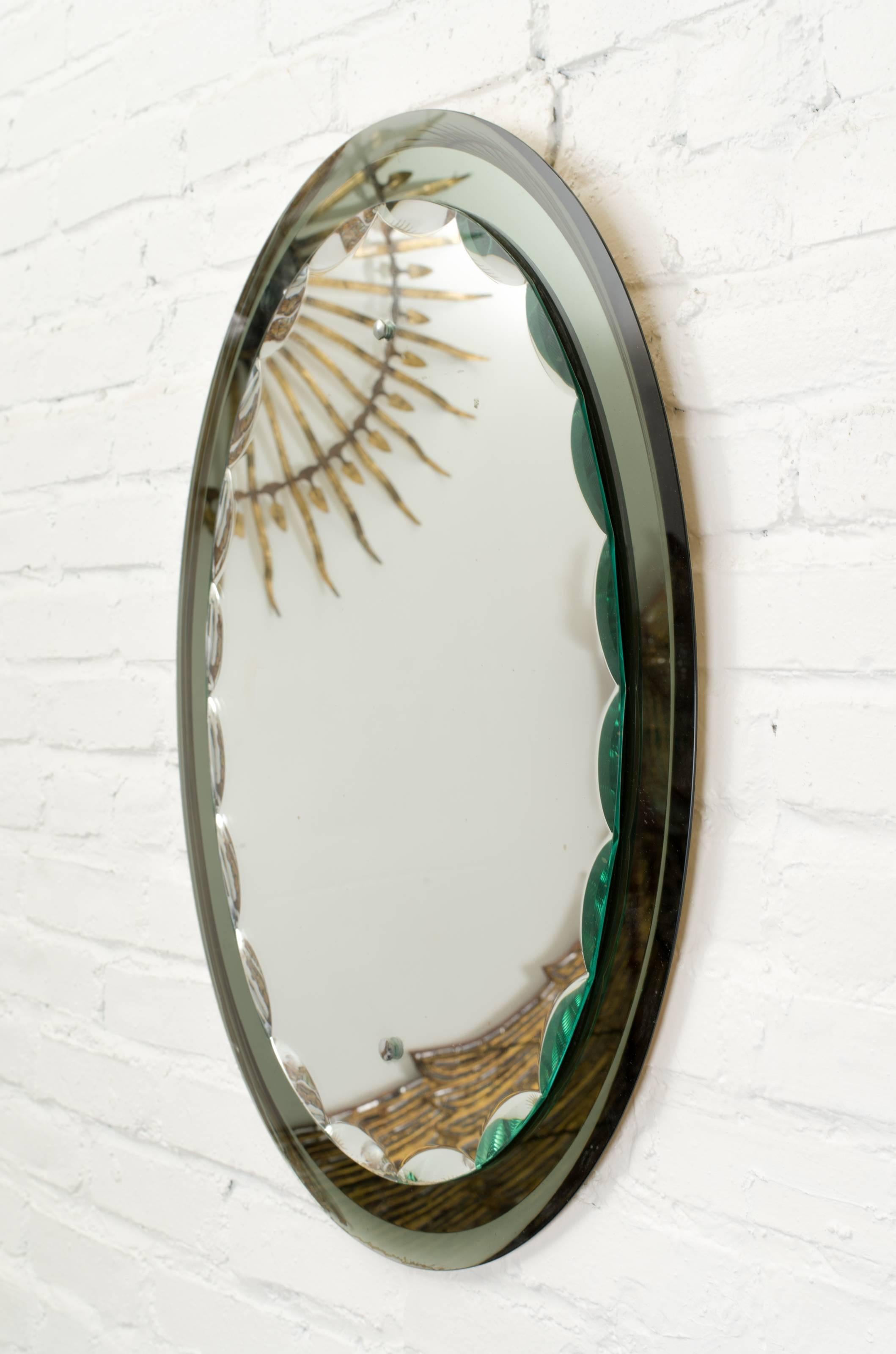Mirror by Italian maker Cristal Art.
Green glass frame with decorative bevels on the edges of the centre mirror.