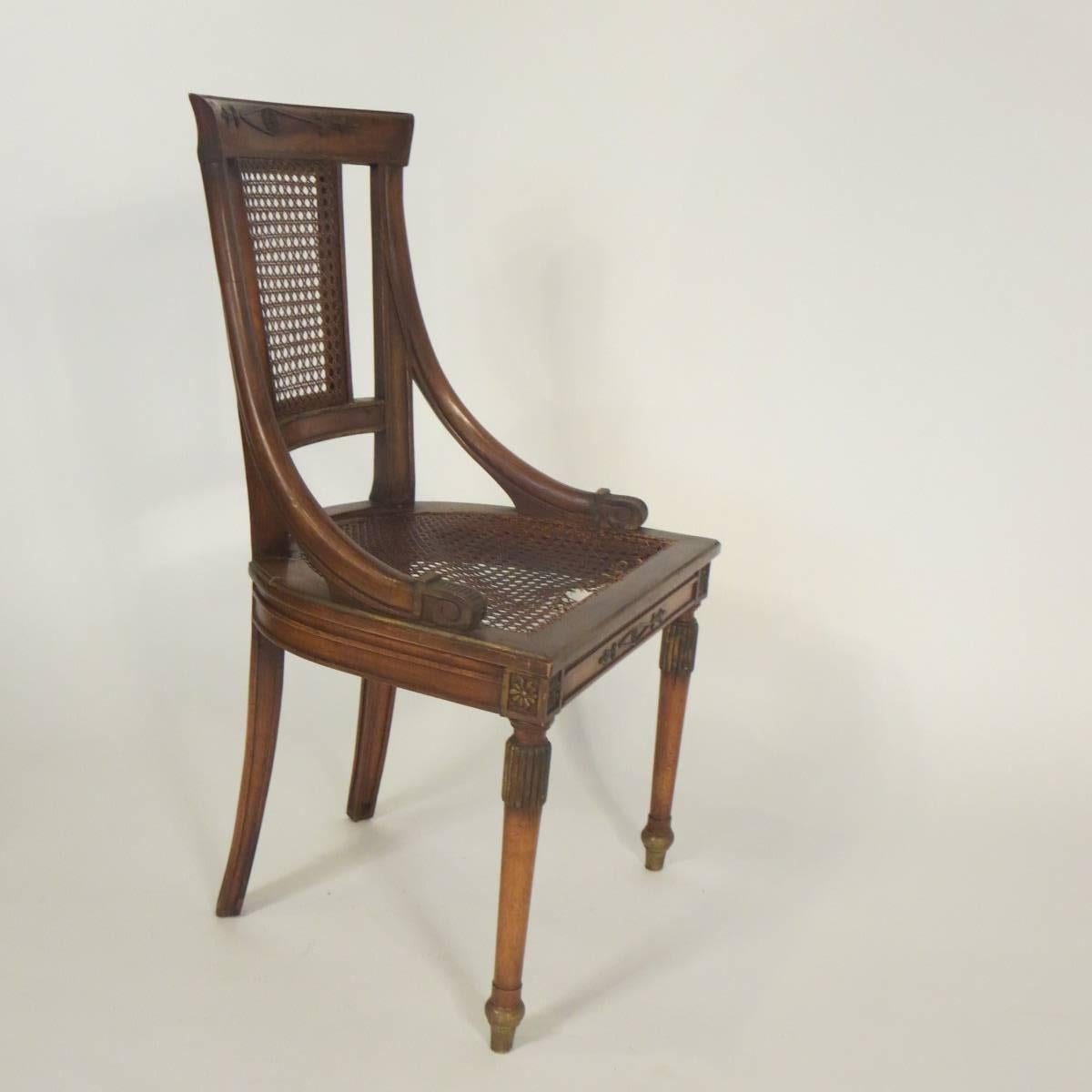 Four 1960s hand-carved Regency style caned side chairs from Italy.