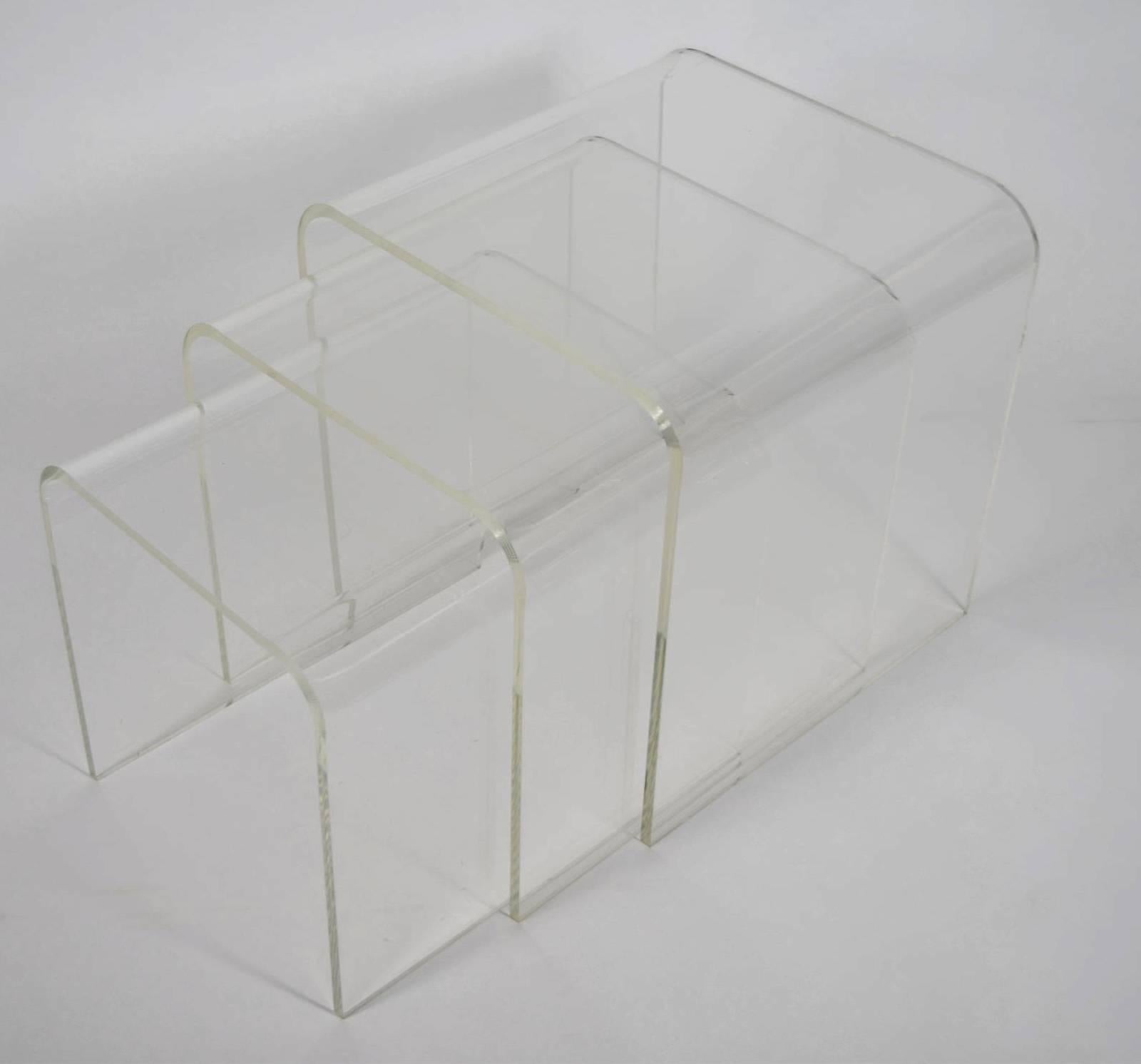 Set of three Lucite nesting tables. Lucite is very thick and substantial. Measurements are for the largest table.