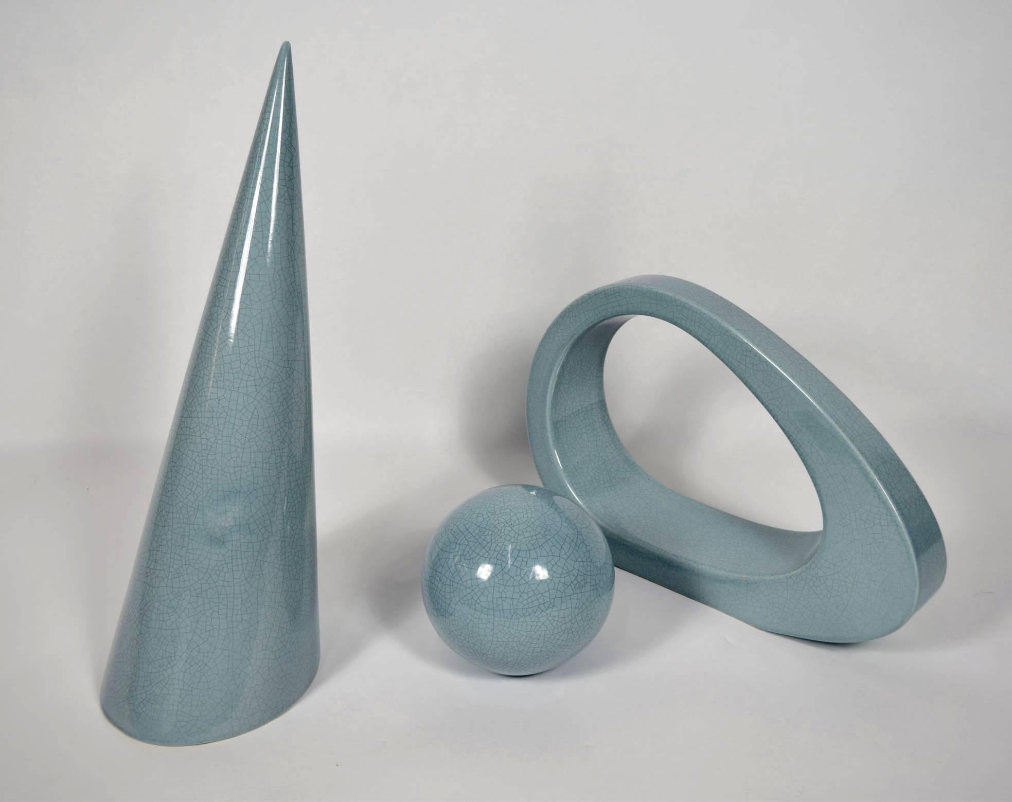 A really nice set of three ceramic pieces by Jaru. Ceramic has a crackle pattern and pieces are a light blue. Cone is 23.5