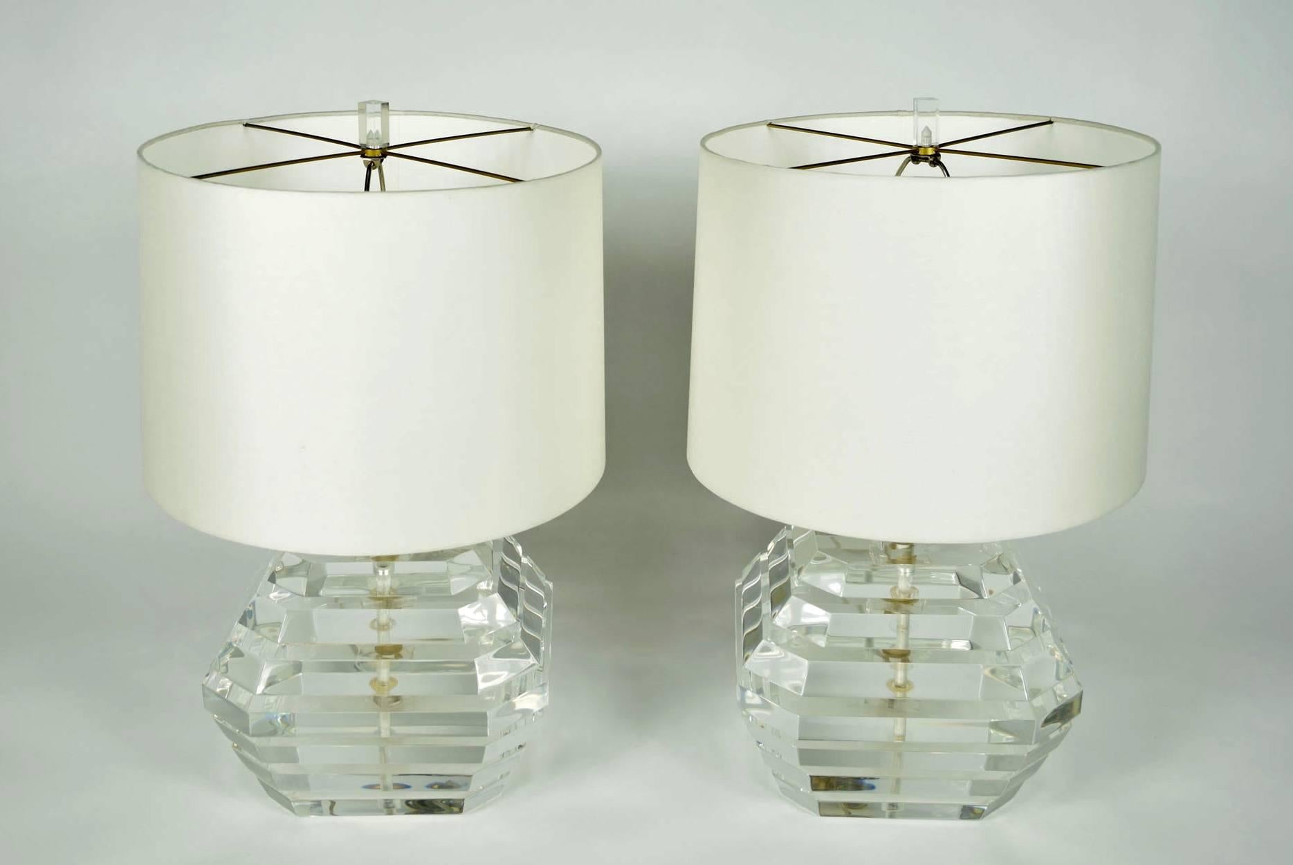 This is a really nice pair of Lucite lamps by George Bullio. They are stacked thick chunks of Lucite around a chrome column. The Lucite is clear and shiny. The lamps are square with a Lucite finial. Shades are not included.