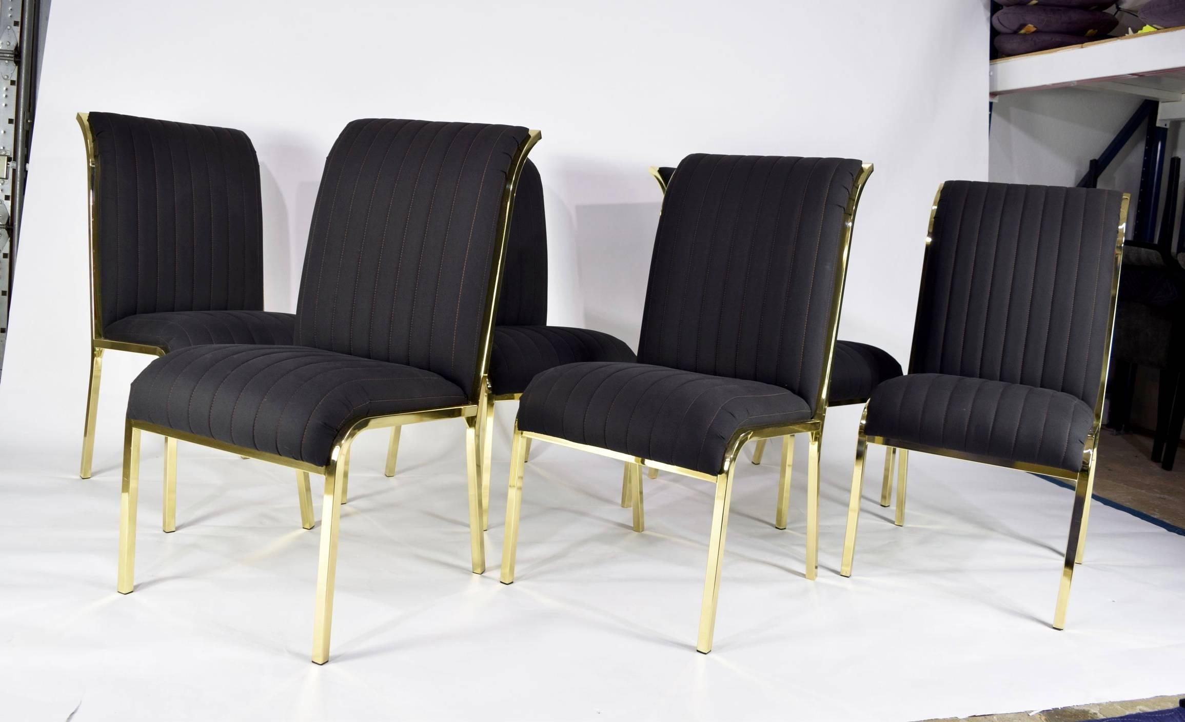 This is a beautiful set of six dining chairs by DIA. The chairs have a brass finish frame which is in excellent condition. The fabric is a black/grey which is beautiful but of course the chairs can be reupholstered if desired. We are happy to help