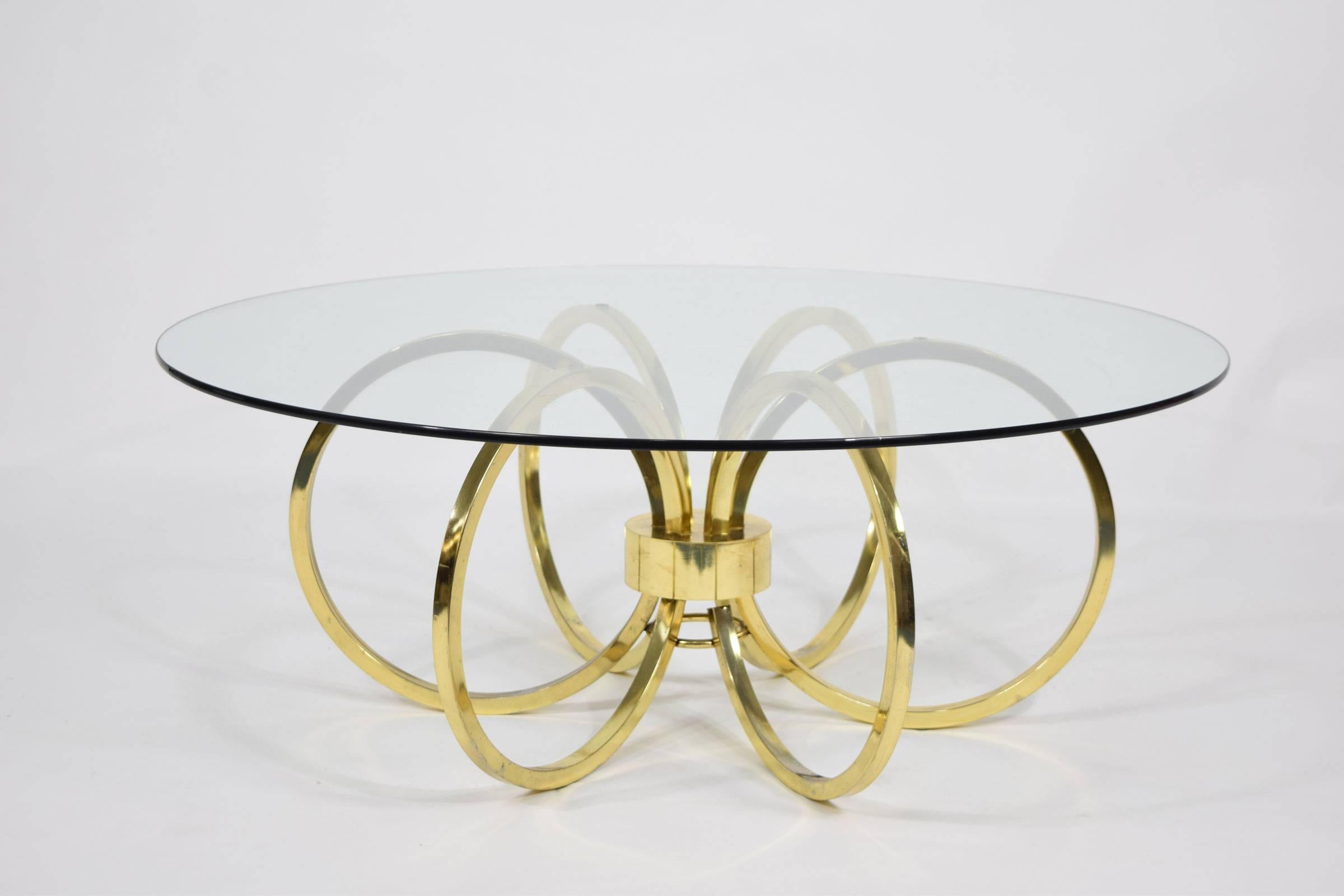 Brass finish coffee table with glass top in the style of Milo Baughman.
