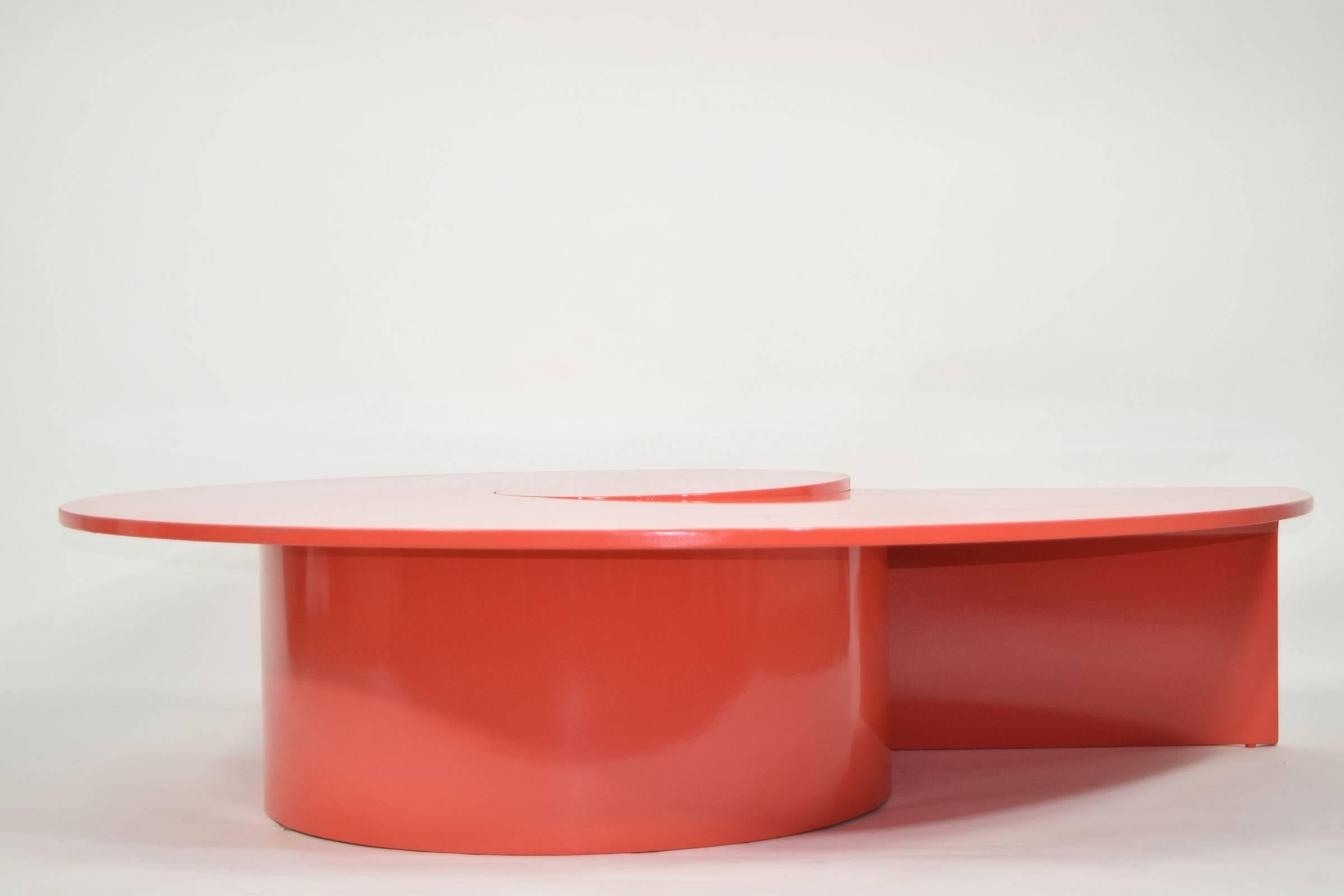 This is a custom coffee table with a swirl design. We have lacquered in a high-gloss red/orange.