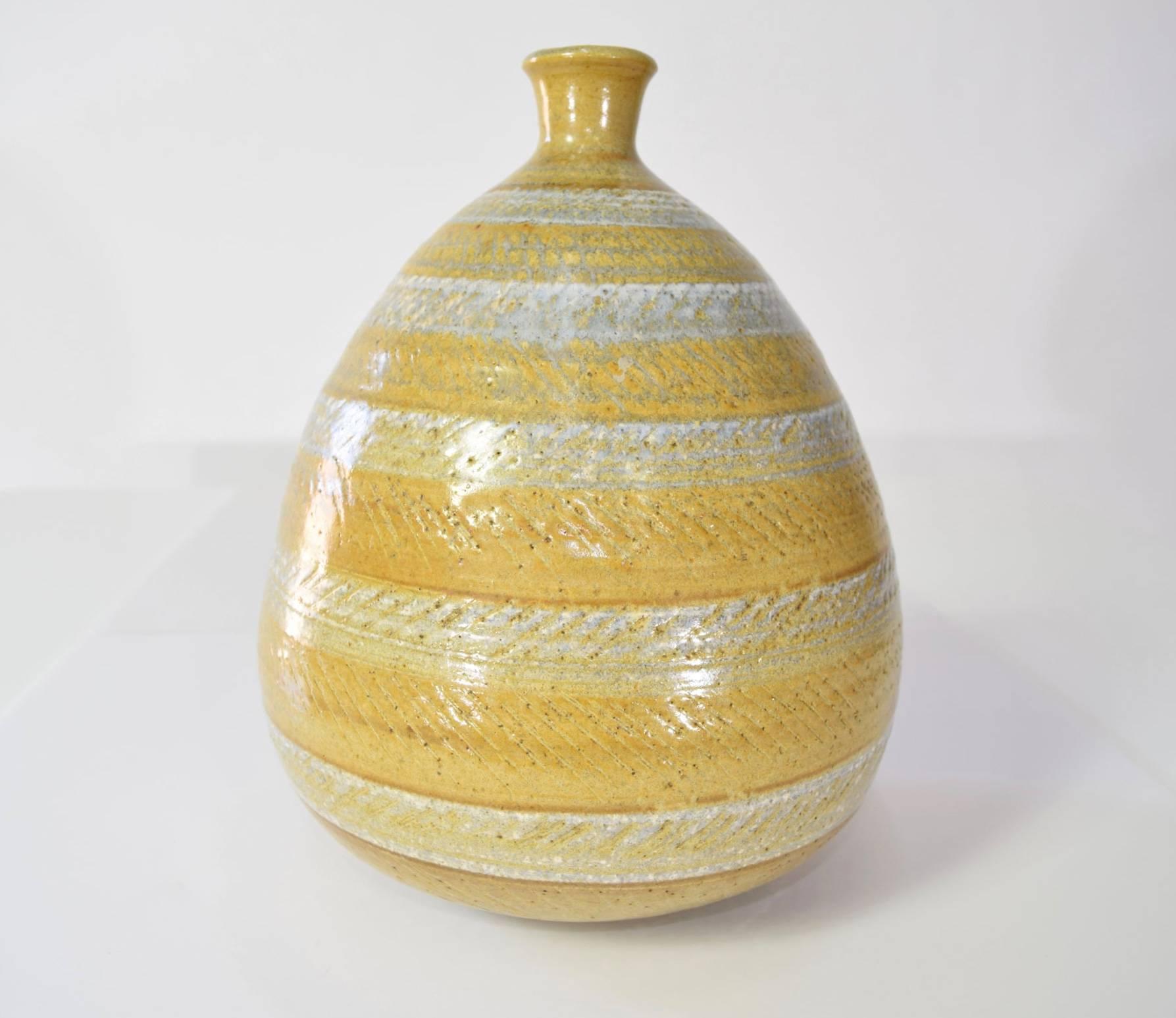 A beautiful vase by Antonio Preto. In a bulbous shape with an incised linear pattern. Piece is signed.
 