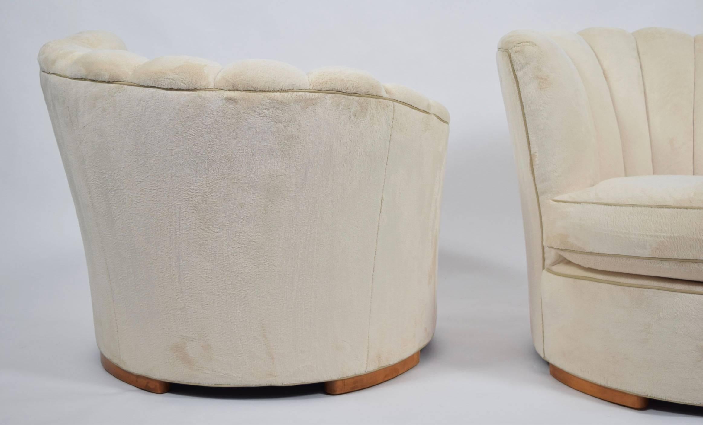 A beautiful pair of deco style lounge chairs with fan backs. Fabric is a high pile velvet which is soft and plush with a cream leather trim. Chairs sit on four rounded wooden legs.