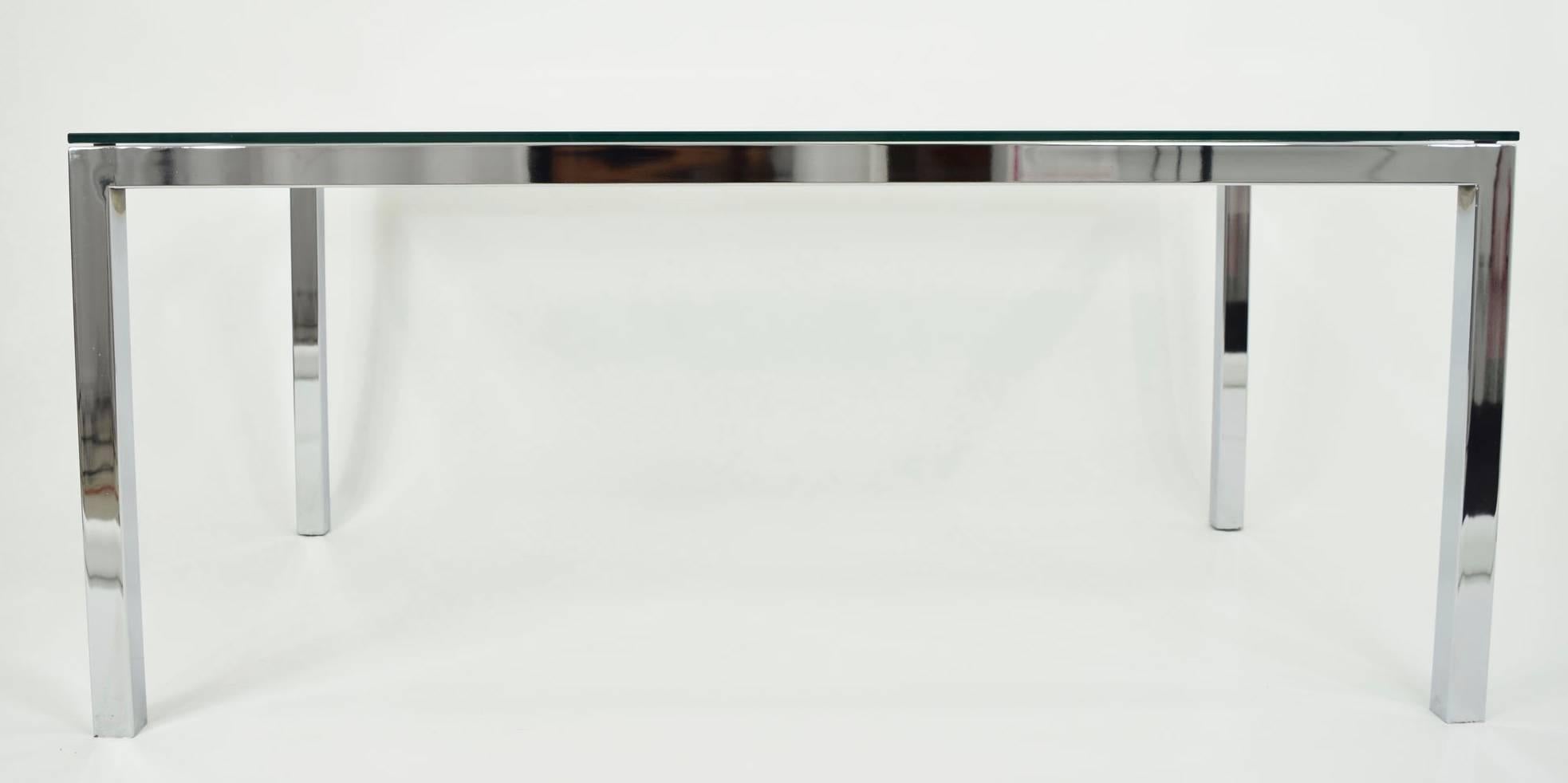 Beautifully simple Milo Baughman chrome and glass dining table. Glass slightly floats on frame of table. Can also be used as a desk.