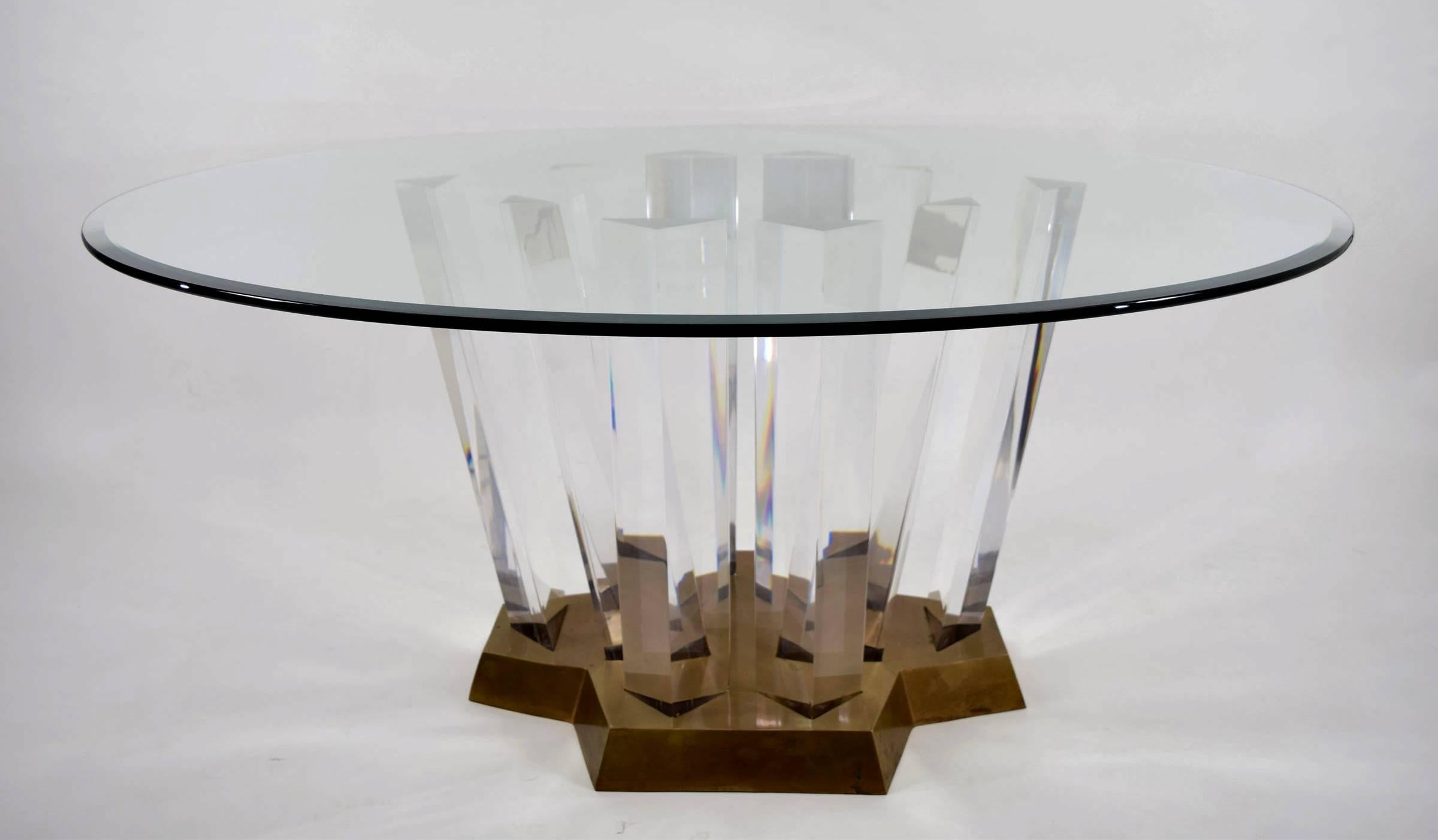 This is a gorgeous dining table with 10 thick triangular towers that are anchored in a heavy brass base. Color of base can be changed as desired. Lucite is in beautiful condition. Currently a 60