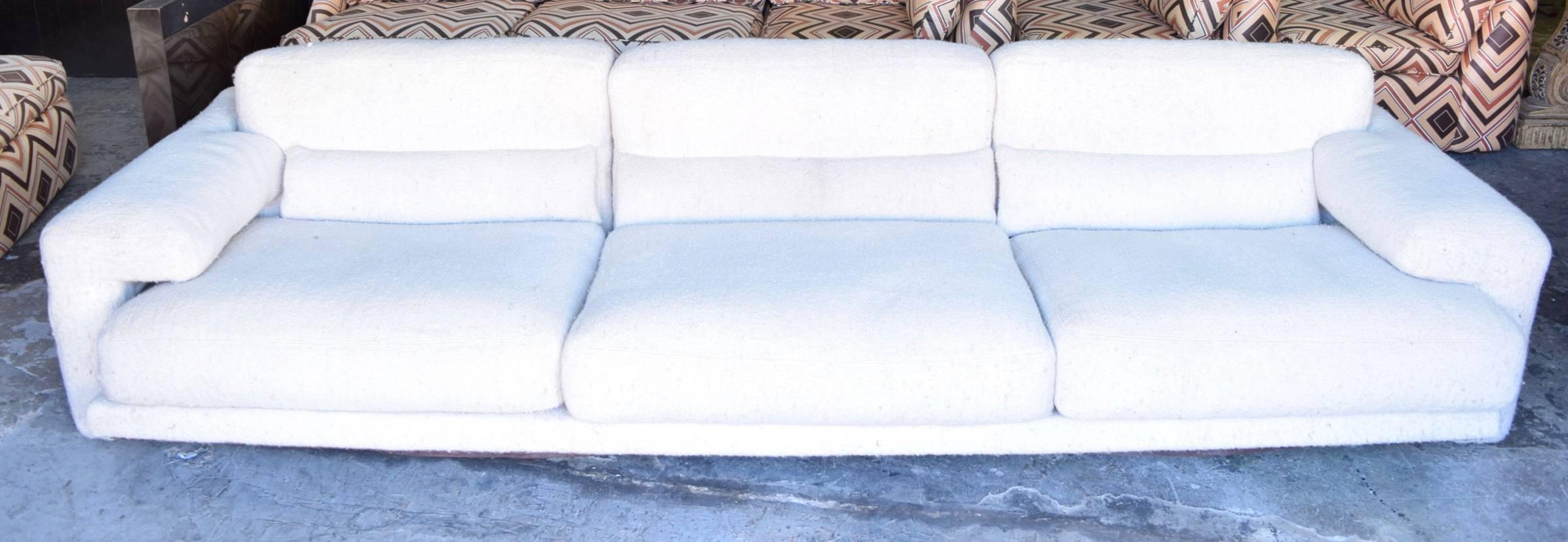 This sofa has great looks, deep seating high-quality construction and sex appeal! It does need reupholstery or a good cleaning which we can help with. Wool upholstery on sofa. Cushions are very heavy and down filled. The back is beautiful so sofa