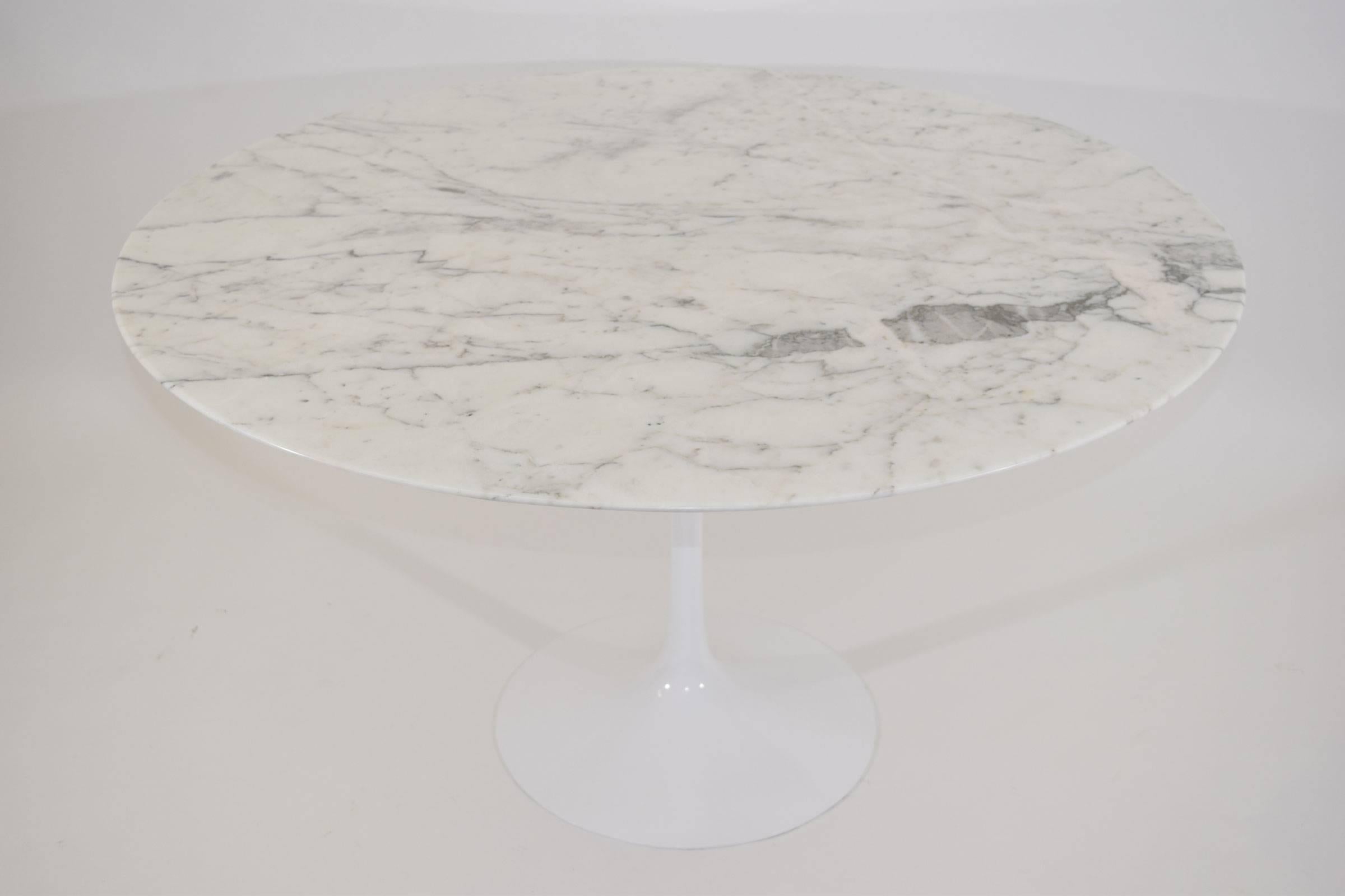 The base is stamped Knoll production and made of steel. It is very heavy. The top is new and done in marble from Italy.