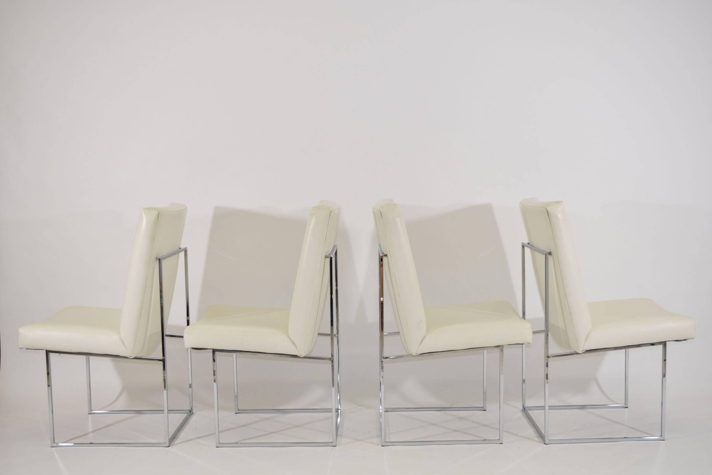 This is a set of four Milo Baughman or Thayer Coggin "1187" armless dining in white Naugahyde. We have another set of four of the same chairs available to make eight if desired. The chairs are white but some of the photos make them look