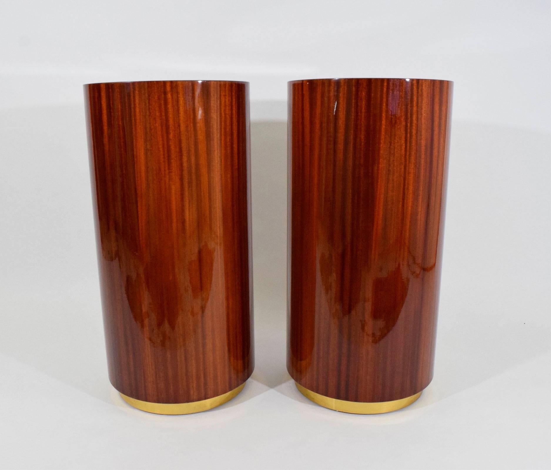 High gloss lacquer on rosewood bases with brass trim on slightly recessed bottom. These can be used as pedestals or as bases to a console. They can also be cut down and used as dining or desk table bases.