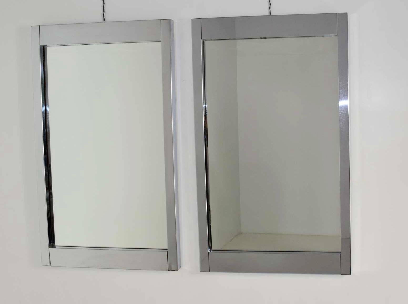 A beautiful pair of clean lined chrome frame mirrors.