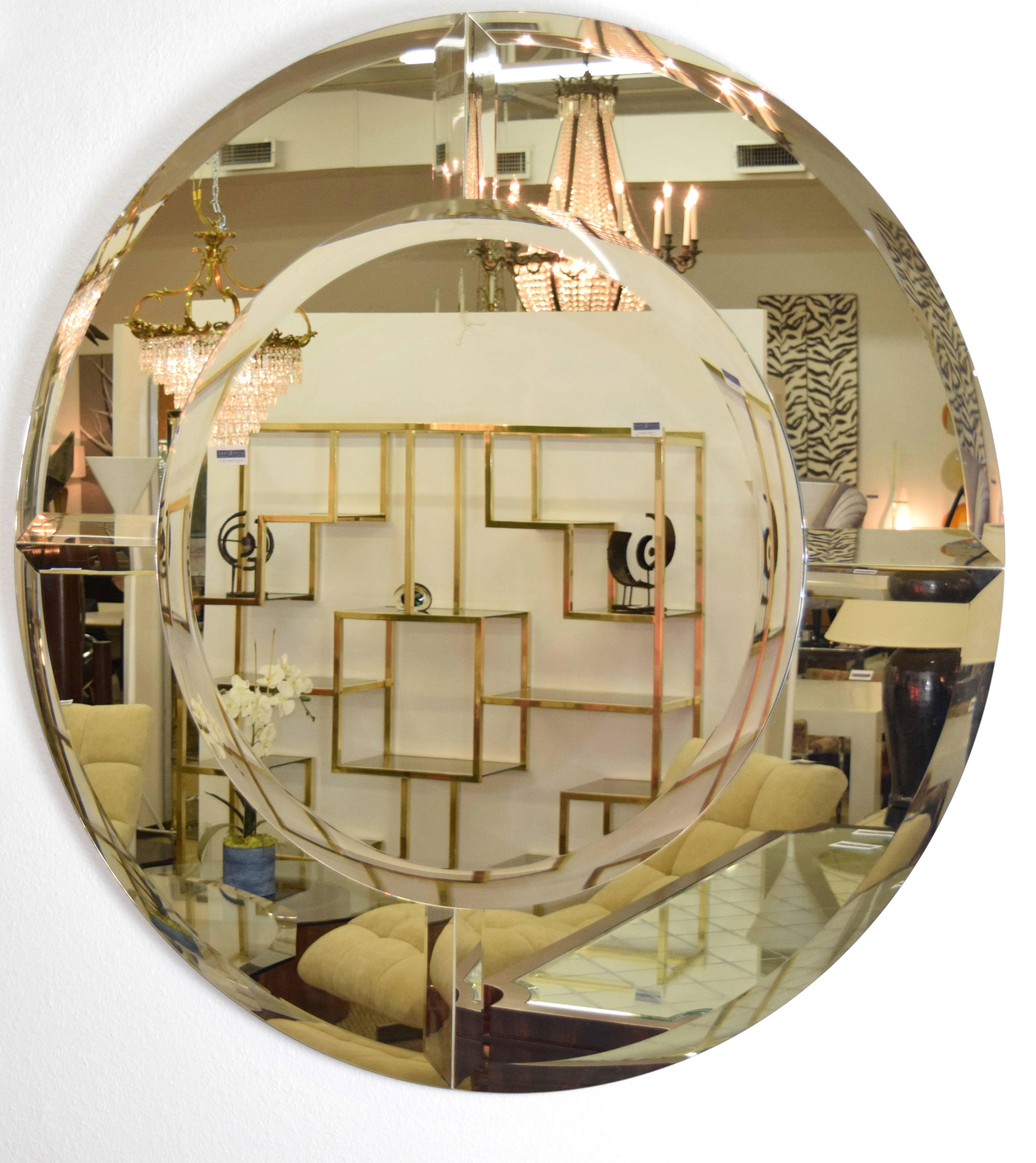 This is a large beveled mirror by Karl Springer. Called the "Saturn" mirror. It has four sections around the border with beveled mirror and a center mirror that is beveled. Very beautiful and simple.
 